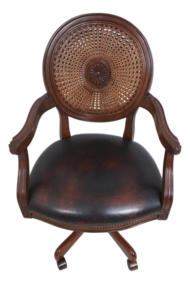 Vintage French Carved Cane Back Swivel Leather Desk Chair: Age Approx. 20 Years Old Details Mahogany Fine Carved Details High Quality Construction Nicely Tooled Leather Double Cane Back Traditional Style Tack Head Trim Adjustable Height Rolling