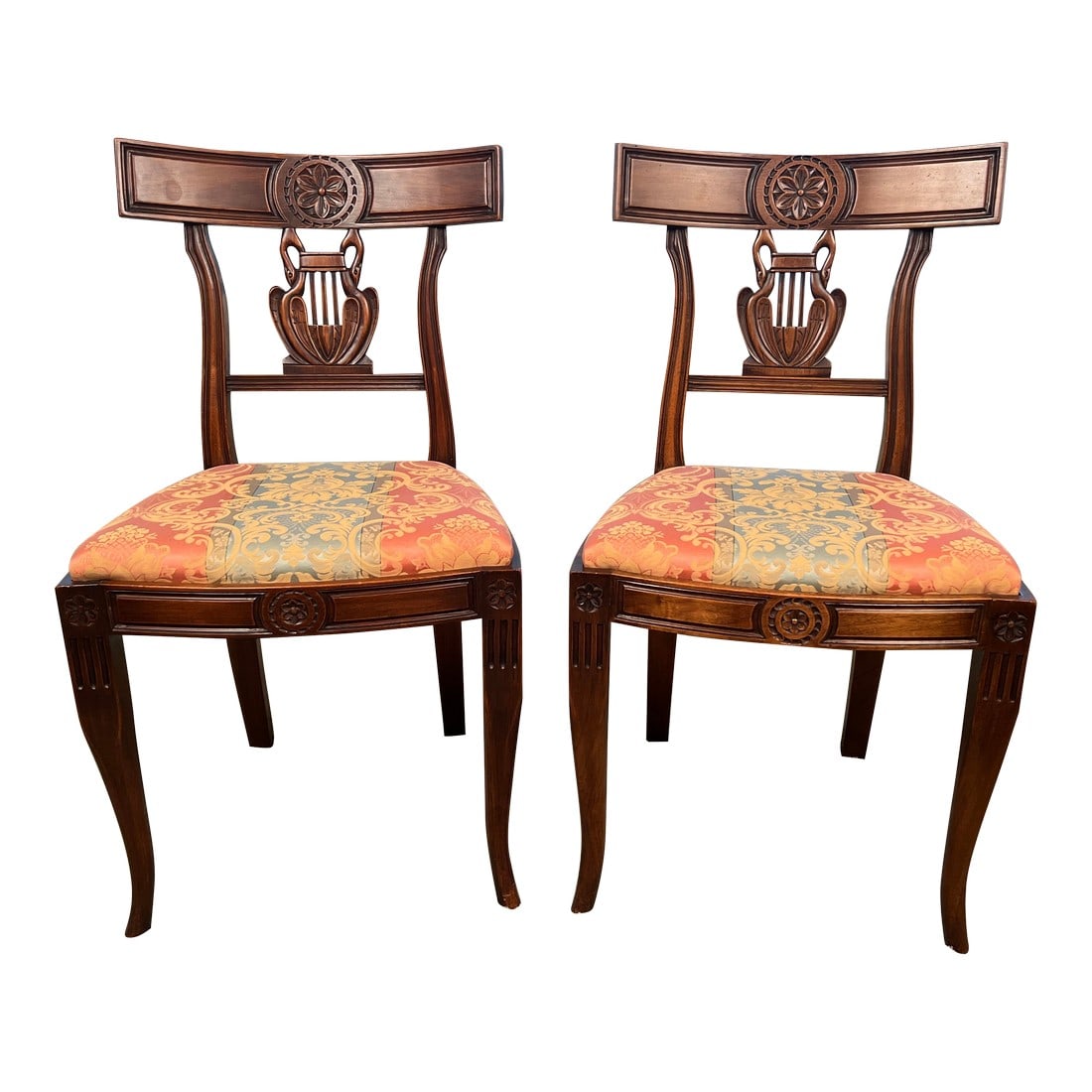 Pair of Late 19th Century Provincial French Lyre-Back Dining Chairs, Empire Revival: A refined pair of American Empire Revival dining chairs, dating to the late 19th to early 20th century. Executed in the Neoclassical taste inspired by French Empire design, each chair features a