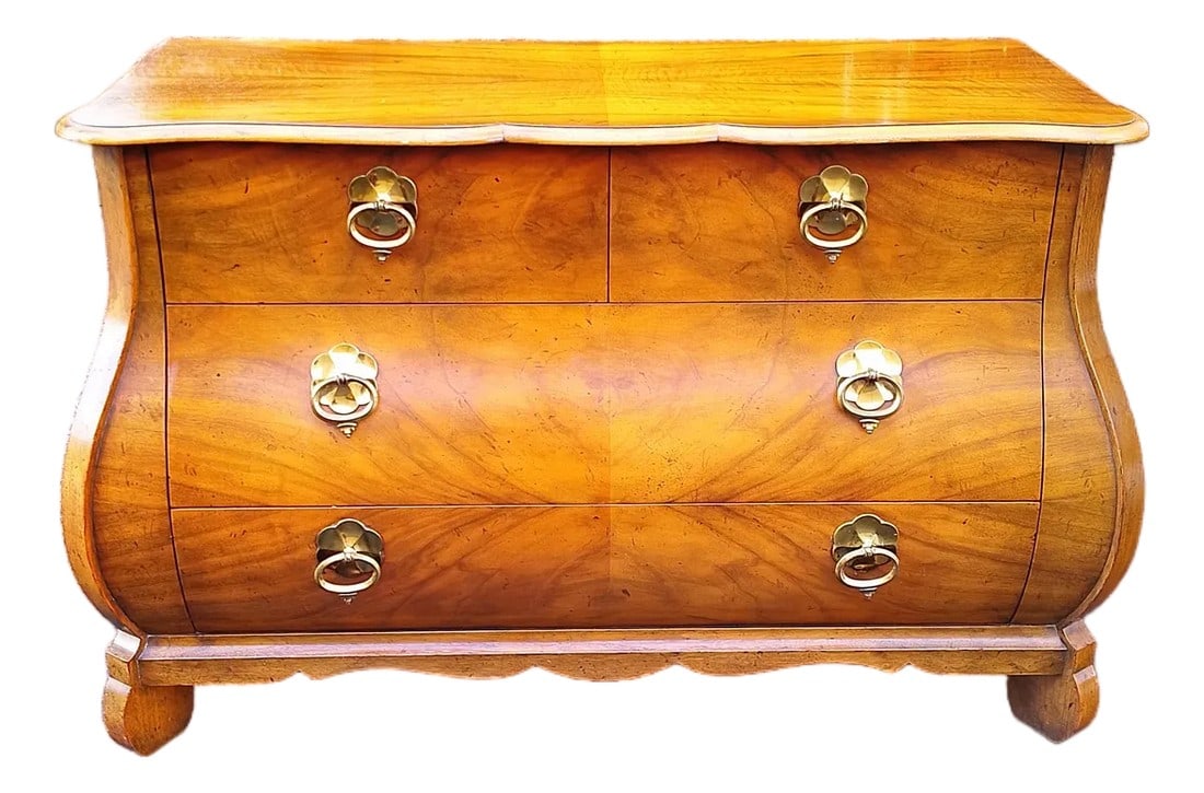 1980s Baker Furniture Serpentine Bachelor's Chest: Elegant serpentine-front chest by Baker Furniture Company, crafted in richly figured walnut veneers with warm golden undertones. The bombe silhouette, softly curved case sides, and shaped bracket