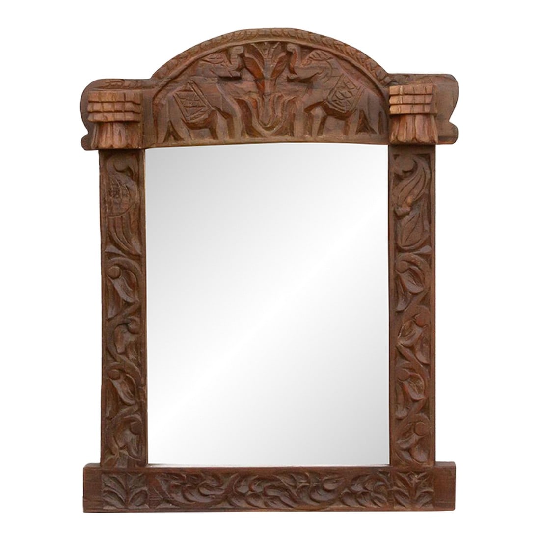 Royal Elephant High-Relief Carved Mirror: A mirror that acts as a talisman. This striking wall mirror is framed by a heavy, architectural surround inspired by the temple entrances of rural India. The deep, 5.5-inch cornice at the top