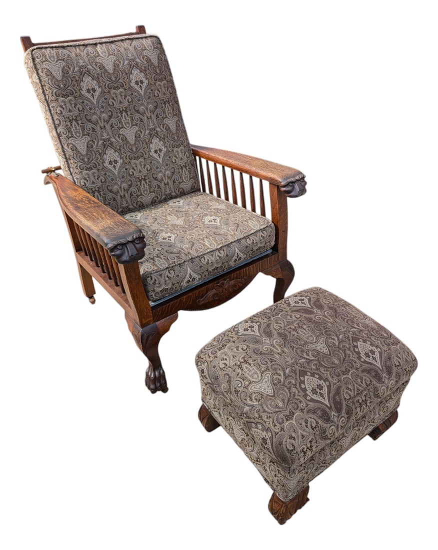 Antique Arts & Crafts Carved Oak Morris Recliner & Ottoman: Wonderful Mission Style Morris adjustable armchair, with carved Lions head arms and feet. Paisley upholstery, and matching ottoman. The chair has been reupholstered, and reinforced on the bottom.