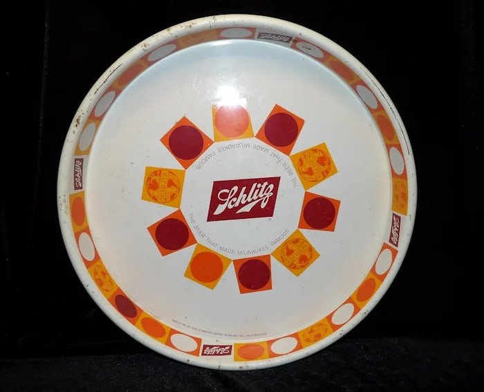 Vintage 1968 Schlitz Beer Tray: Round 1968 metal litho beer tray from Schlitz featuring a classic bar scene and vintage branding. Shipping:Domestic: Flat-rate of $18.00 to anywhere within the contiguous U.S.International: Foreign