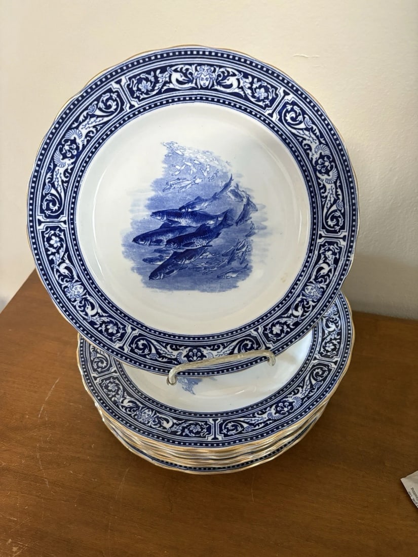11 Royal Doulton Artist Signed Flow Blue Fish Plates: They all measure 10 1/4” and are artist signed and marked. They have no chips, cracks or repairs. They will be shipped in two boxes for safety purposes Shipping:Domestic: Flat-rate of $50.00