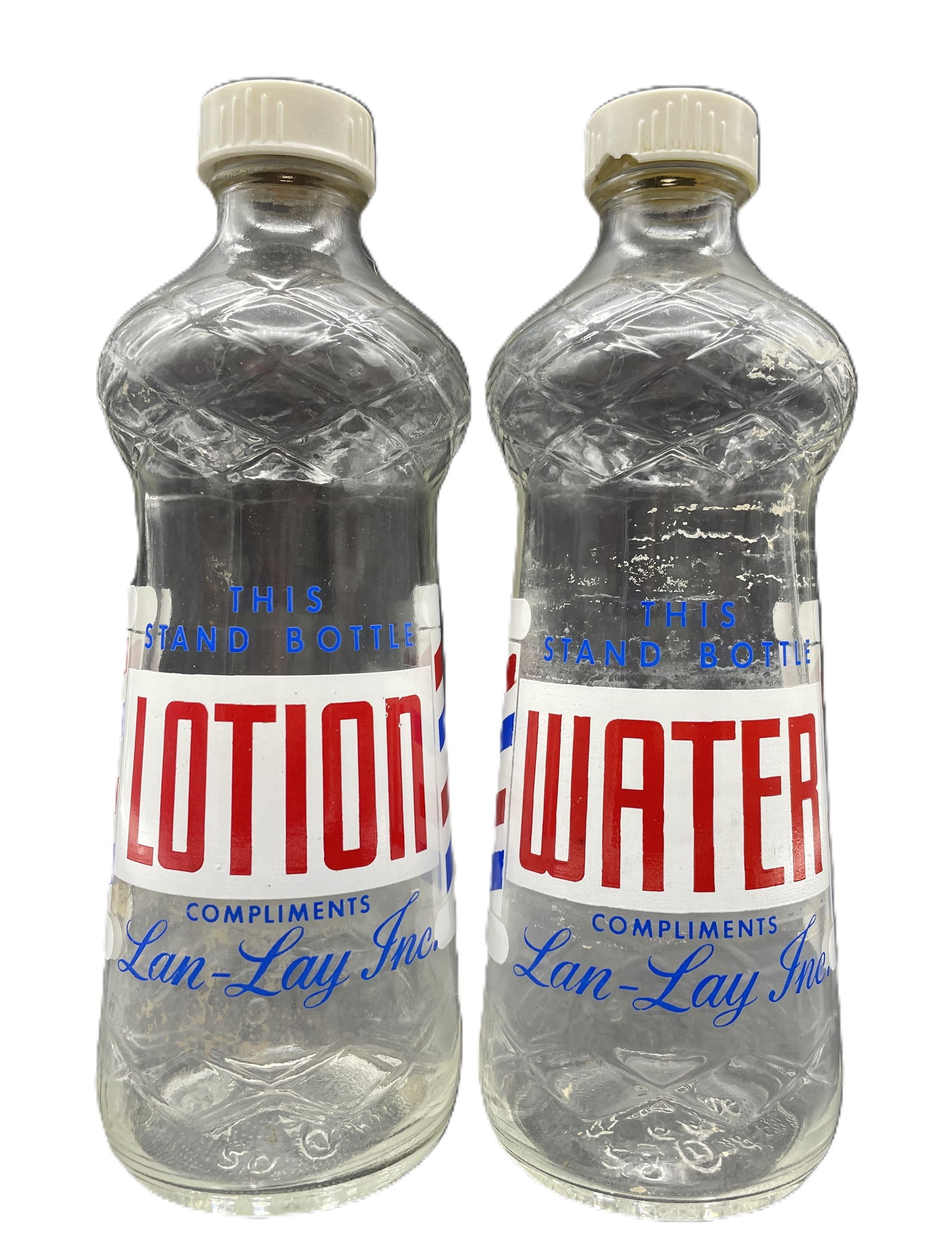 2 DURAGLASS THIS STAND BOTTLES WATER & LOTION COMPLIMENTS LAN-LAY INC: Date/Period: Approx 1950'sDimension: Approx. 7.5" x 2" wideMaterial: glassAdditional Information: 2 DURAGLASS THIS STAND BOTTLES WATER & LOTION COMPLIMENTS LAN-LAY INC Shipping:Domestic: Flat-rate