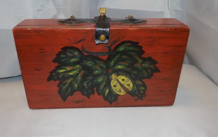 Vintage 1962 Enid Collins Wood Box: Enid Collins wooden box handbag with replacement handle. 11 ¾” x 6 ½” x 3”. Shipping:Domestic: Flat-rate of $17.00 to anywhere within the contiguous U.S.International: