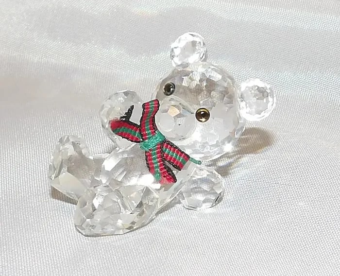 Swarovski Silver Crystal Kris Bear Figurine: Adorable Swarovski Silver Crystal Kris Bear figurine holding a crystal sunflower. Shipping:Domestic: Flat-rate of $15.00 to anywhere within the contiguous U.S.International: Foreign shipping rates