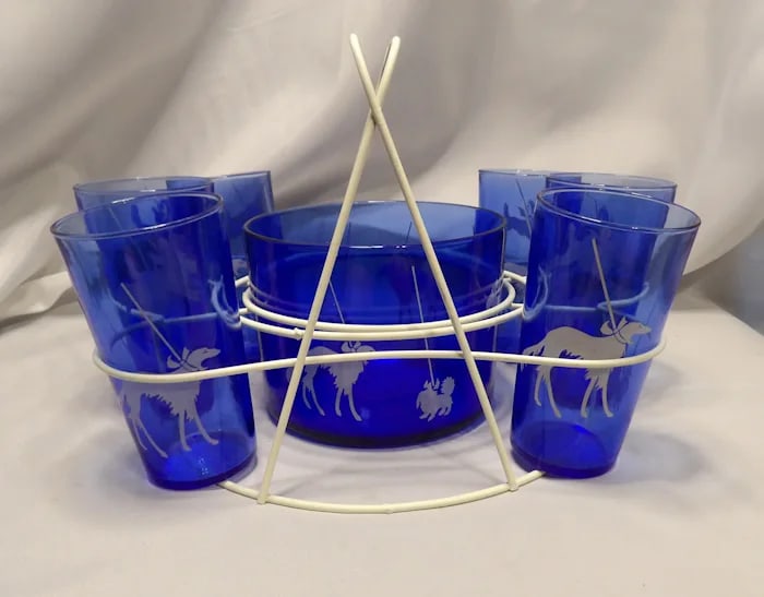 1930’s Cobalt Blue 8-Piece Dog Set: Rare 1930s 8-piece cocktail set in deep cobalt blue glass, featuring a large dog-shaped shaker and seven matching cups. Shipping:Domestic: Flat-rate of $47.00 to anywhere within the contiguous
