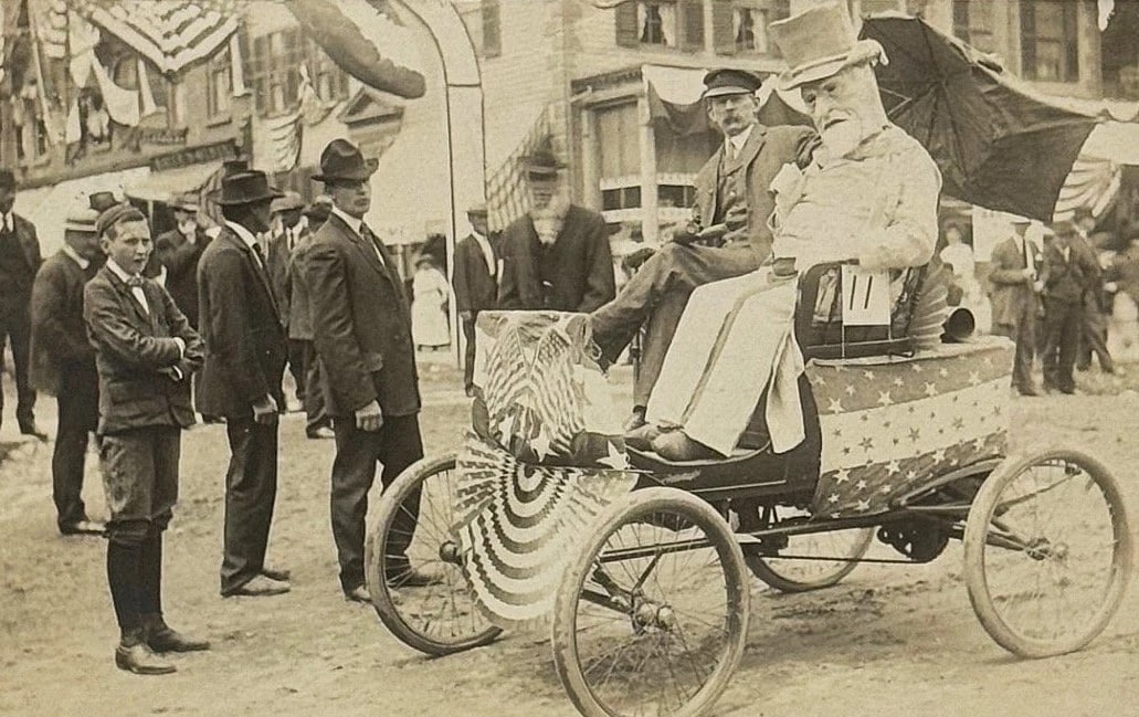 Real Patriotic Uncle Sam Photo Horseless Carriage Parade American Flags 1907: Real photo patriotic postcard of an early horseless carriage with a man dressed as Uncle Sam. The carriage is decorated with American Flags and patriotic star bunting. The back of the card states -