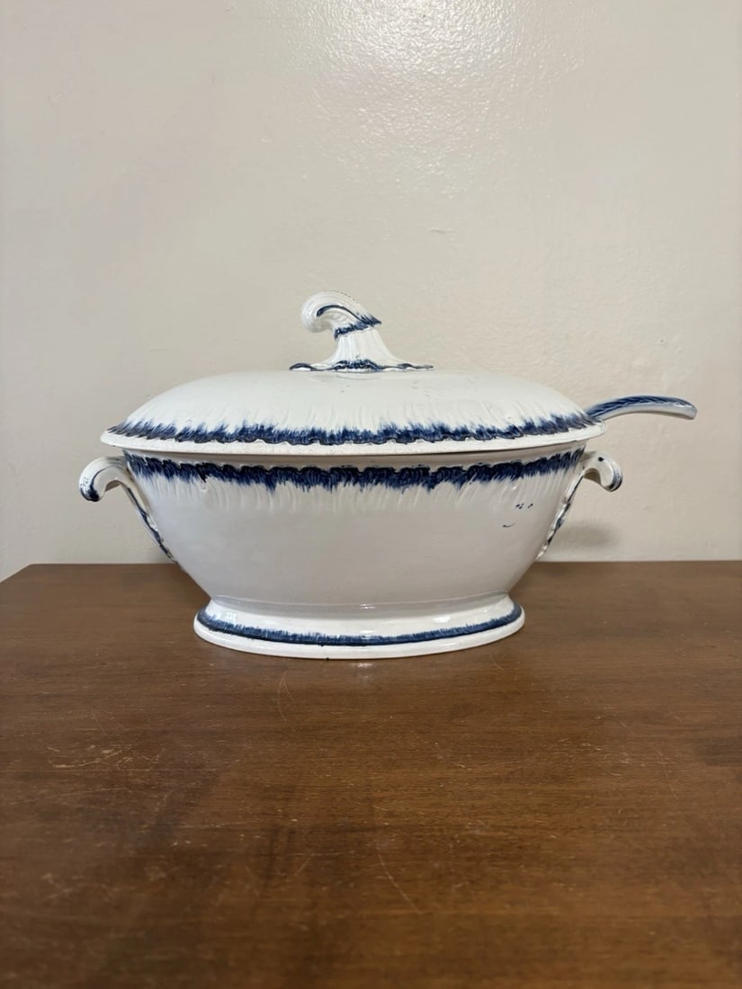 3pc Leeds Blue Feather Edge Soup Tureen: It measures 13 1/2” x 8 7/8” x 8 5/8” high and the ladle measures 11 3/8” x 3 1/8”. It dates around the 1850’s. The base has a flake on the top rim, the lid has