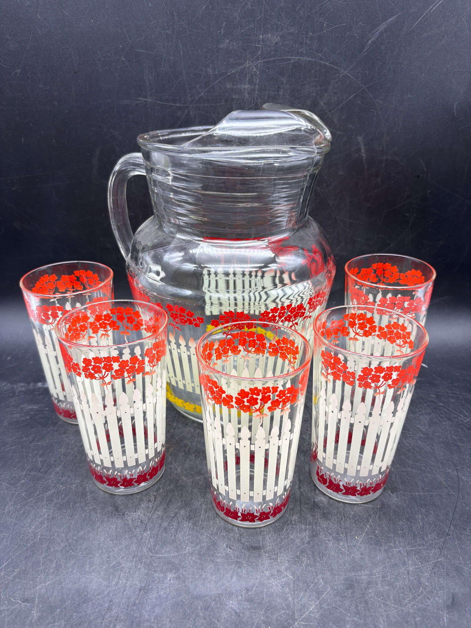 1950's Glass Pitcher Flowers Picket Fence and Set of 5 Glasses Juice Lemonade: Date/Period: Approx 1950'sDimension: Pitcher is approx 9" tall x 5 " diam Glasses are apporx 4.75" tall x 2.5 diamMaterial: glassAdditional Information: 1950's Glass Pitcher Flowers Picket Fence and