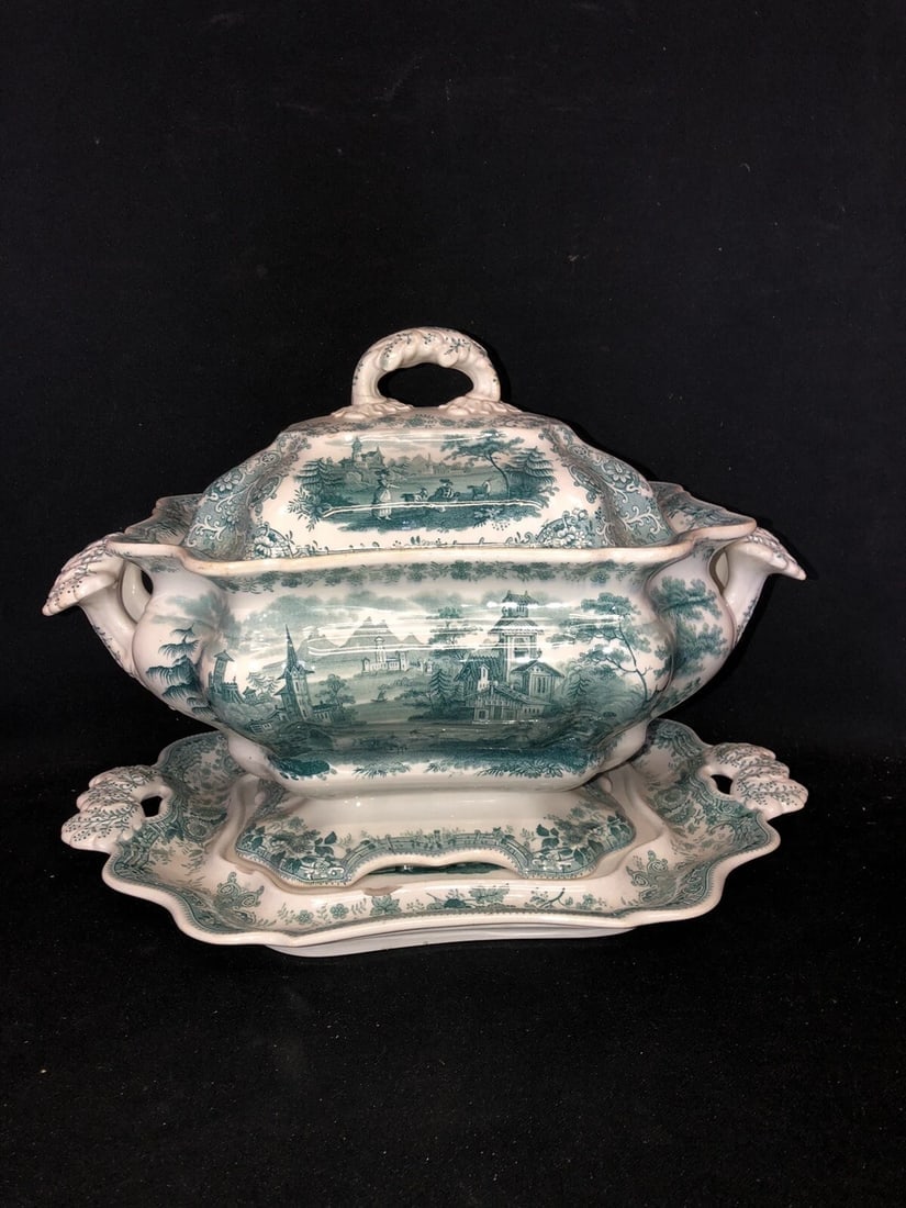 3pc Tyrolean Staffordshire Soup Tureen: The tray measures 14 3/4” x 10 1/2” and has three chips and two flakes. The base measures 13 3/4” x 9” x 6 1/2” and is marked. It has two chips and wear where the lid