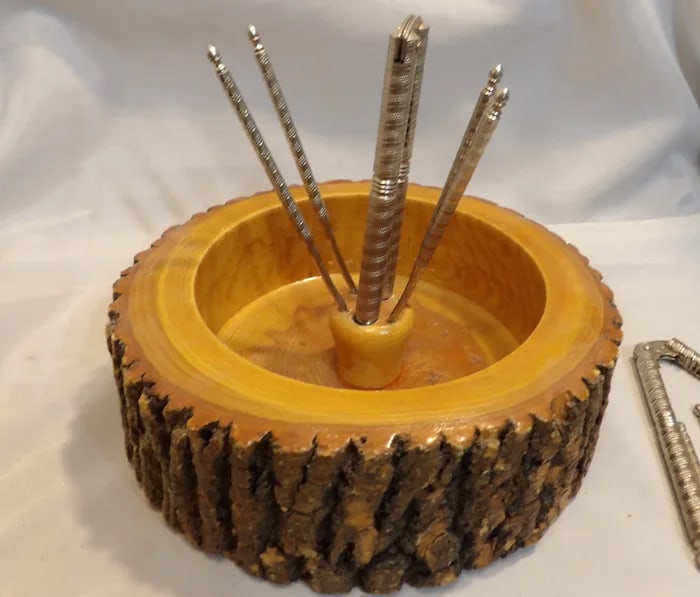 Live Edge Nut Bowl 2 crackers: Rustic wooden nut bowl with a natural 'live edge' design, accompanied by two metal nut crackers. Shipping: Domestic: Flat-rate of $17.00 to anywhere within the contiguous U.S. International: Foreign s