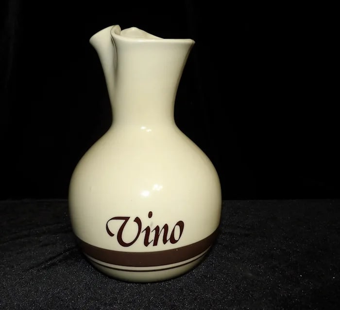 Vintage McCoy Pottery Wine Carafe Pitcher: Classic McCoy pottery wine carafe or pitcher with a hand-painted grape cluster design and a warm brown glaze. Shipping:Domestic: Flat-rate of $19.00 to anywhere within the contiguous