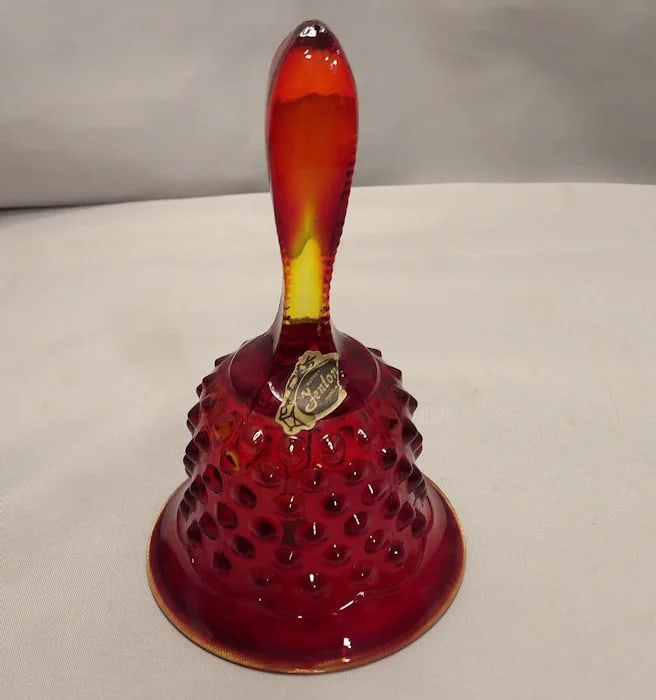Fenton Amberina Ruby Hobnail Glass Bell: Handmade Fenton glass bell with ruby gradient. Original sticker (1970-1985). 5 ¾” tall. Shipping: Domestic: Flat-rate of $15.00 to anywhere within the contiguous U.S. International: Foreign