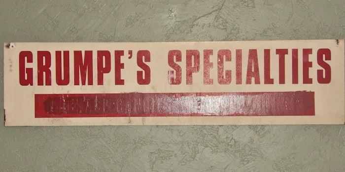 Vintage Wooden 2 Sided Store Sign: Double-sided ""Grumpe's Specialties"" sign. One-of-a-kind. 48” x 12”. Shipping: Domestic: Flat-rate of $36.00 to anywhere within the contiguous U.S. International: Foreign shipping rates a