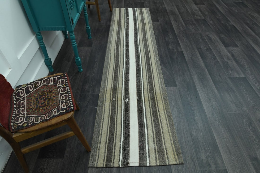 2x9 Faded Turkish Rug: Title: 2x9 Faded Turkish Rug Origin: Turkey Date/Period: 1960 - 1970 Materials: Wool and Cotton Size: Width: 2.5 feet; Length: 9.9 feet Description: This Turkish one-of-a-kind Vintage Flatweave Kilim