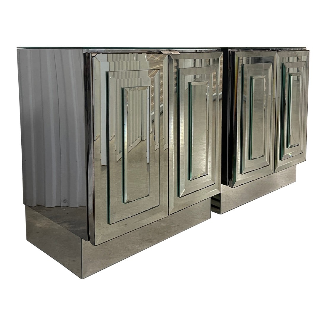 Mid 20th Century Pair of Vintage Ello Mirrored Cabinets: Lovely pair of MCM Ello mirrored cabinets, or nightstands. These case pieces are composed of tiered beveled mirror fronts, chrome clad sides, mirrored plinths, chrome pulls, and each contain a single