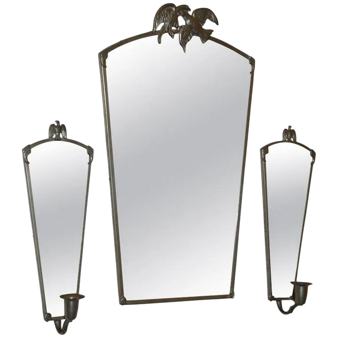 Vintage Swedish Pewter Eagle Mirror and Sconces by Svenskt Tenn: Vintage pewter mirror and mirrored candle sconces with eagle motifs by noted Swedish decorative arts firm Svensk Tenn. Mirror measures 10 3/4"W x 3/8"D x 18 1/2"H. Sconces measure 4 1/2"W x 12