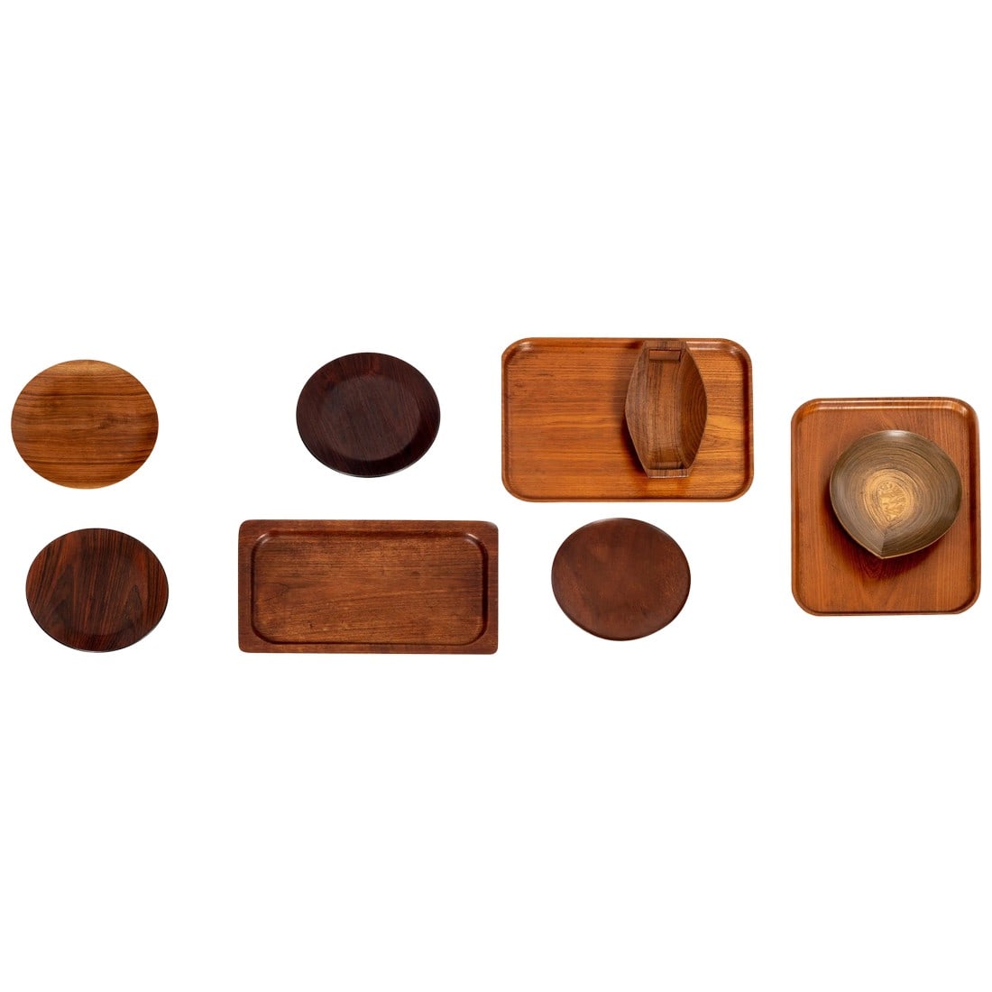 Collection of Wood Serving Pieces: Collection of nine serving pieces, consisting of trays, dishes and bowls. Various sizes 14" x 24" is approximate size of rectangular trays the circular trays are 13" diameter approximately. teak,