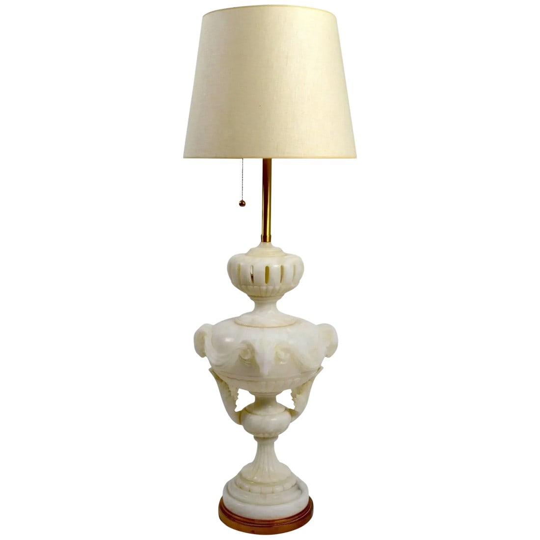 Large Alabaster Lamp by Marbro Co: Unusual; and extra-large carved alabaster lamp by Marbro, in original and working condition. This lamp has carved animal head details, as well as swags and pierced opening details. Hard to find this