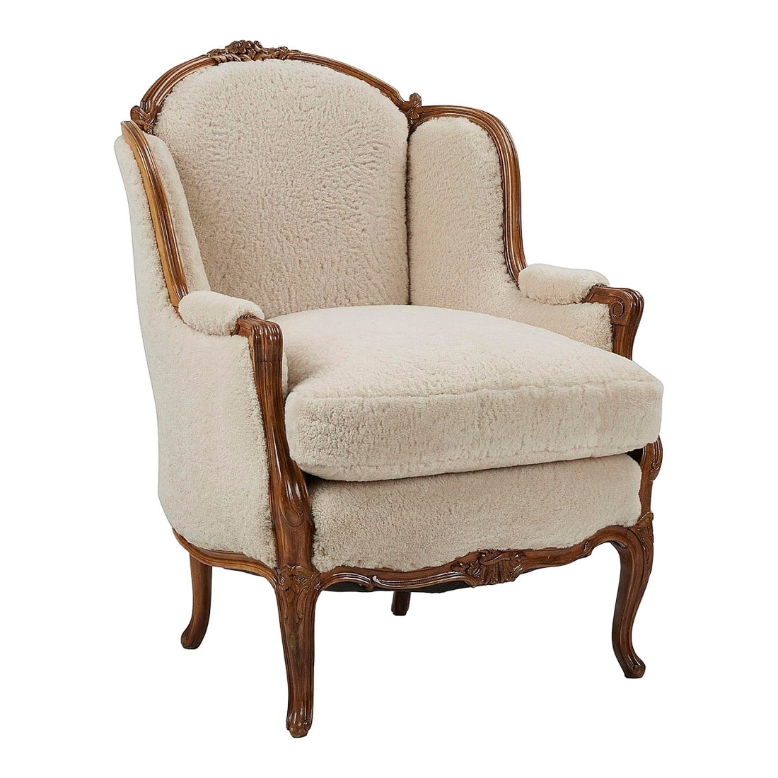 Early 1900s Shearling Berger Armchair: Walnut frame Berger armchair upholstered in natural sheep shearling. This is an antique piece that has been professionally restored and newly reupholstered in natural color shearling. The frame is