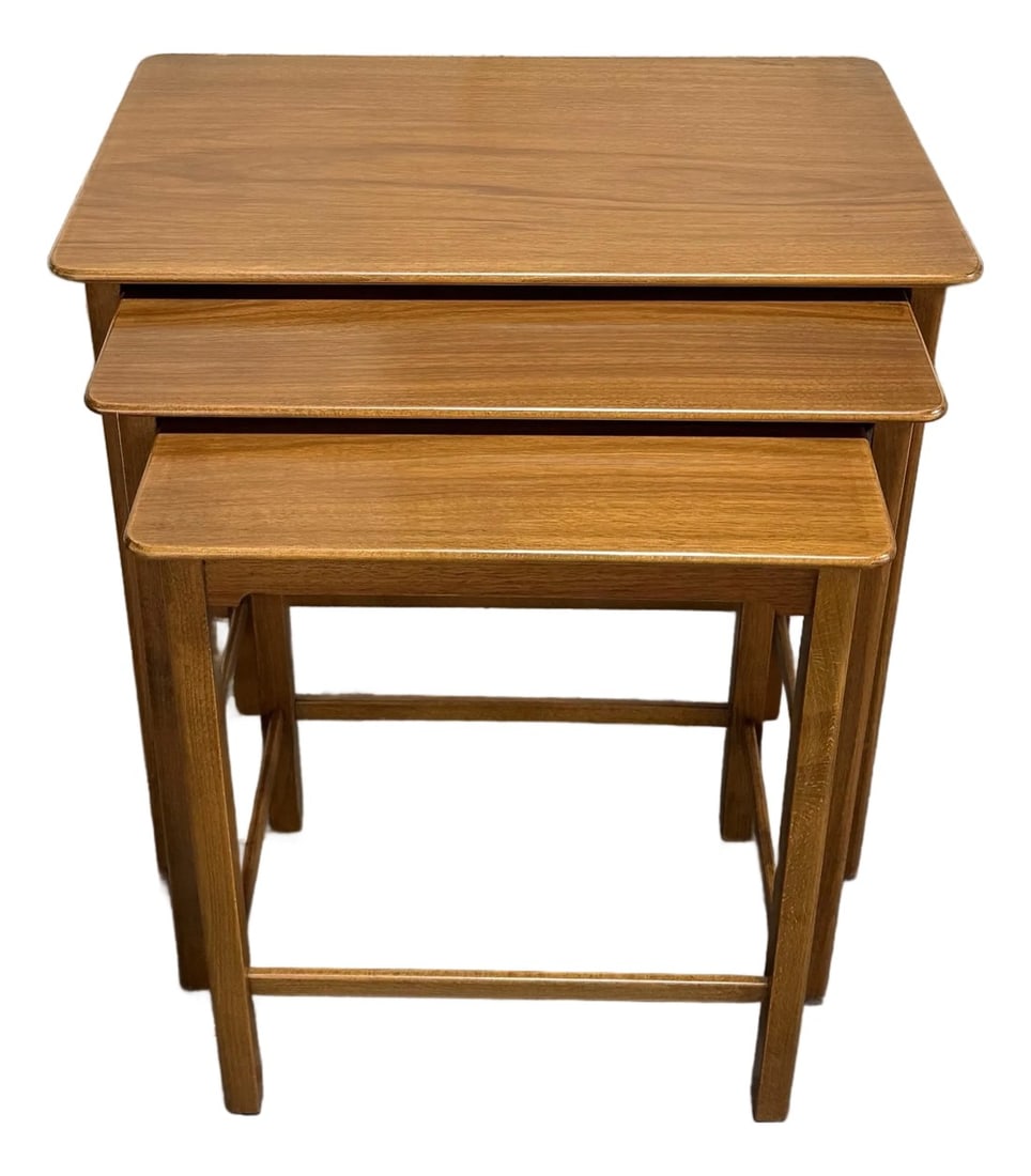 Set of Three Swedish Modern Brown Teak Nesting End Tables C. 1960: Quintessential set of three space-saving nesting tables from Sweden, embodying the functional elegance of the Mid-Century Modern movement. Attributed to the acclaimed Swedish manufacturer, AB Seffle