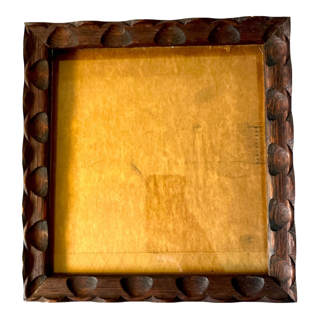 Vintage Hand-Carved Wooden Frame With Raised Scallop and Notched Detailing: This vintage early 20th century wooden picture frame features deeply carved, rhythmic raised scallop and notch detailing along the perimeter, giving it a bold architectural presence. The warm, richly