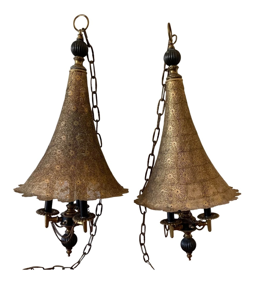 Vintage 1960s Moroccan Moorish Pierced Brass Hanging Lamps - a Pair: Two vintage swap lamps moorish pierced brass filigree floral designs shades with three candle lights and decorated with chains. Each include 10' chainlink. Condition: Alterations: Original