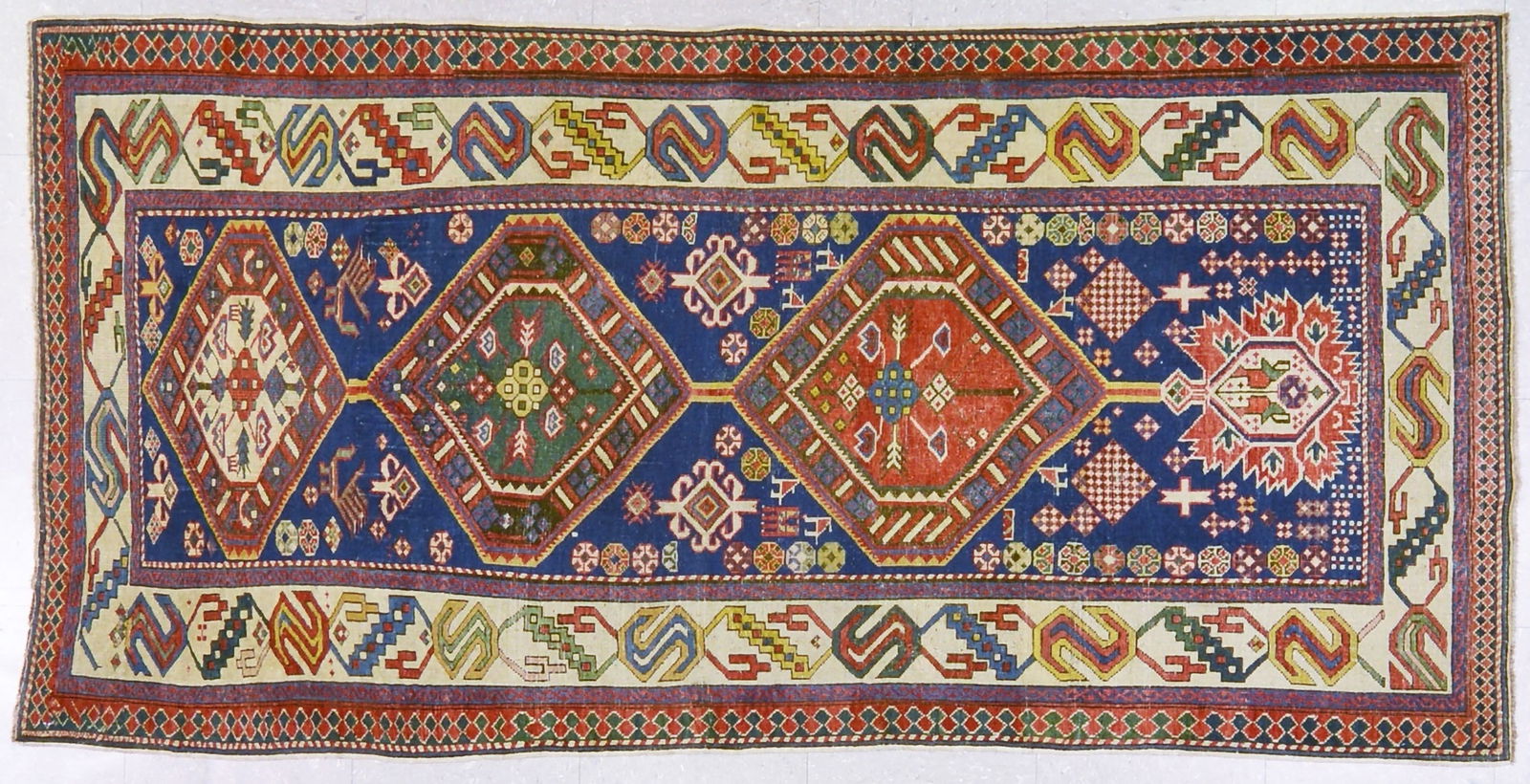 RUSSIAN HAND KNOTTED WOOL RUG: Title: RUSSIAN HAND KNOTTED WOOL RUG Size: 3'3X6'6 Age: ANTIQUE Origin: RUSSIAN Style: CAUCASIAN Material: WOOL Care: PROFESSIONAL Structure: HAND KNOTTED Design: ANTIQUES Reserve: $3,000.00 Shipp