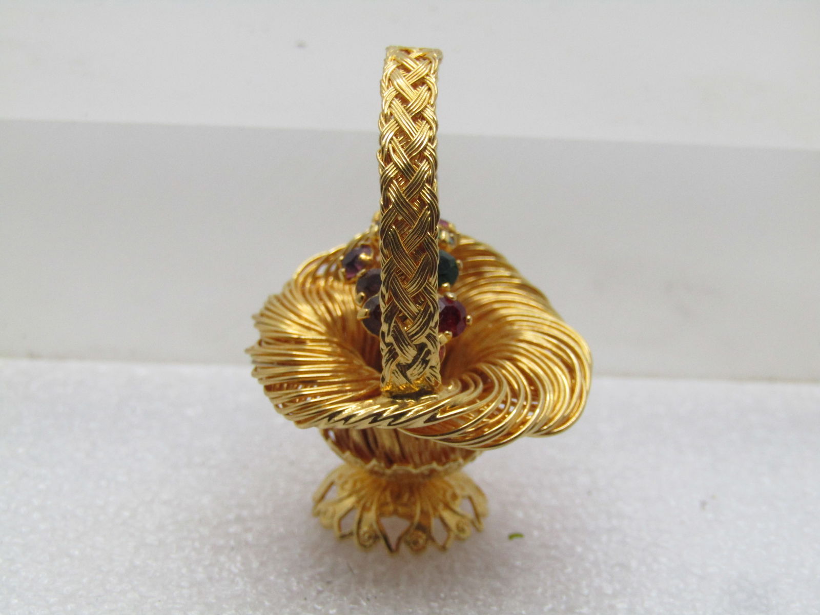 Vintage Rhinestone Floral Basket Brooch, 1960's-1970's: Vintage Rhinestone Floral Basket Brooch, 1960's-1970's. This is a gold tone bsket with wrapped wrie for the basket and handle and a solid gold tone base. The locking pin clasp is attached to the back