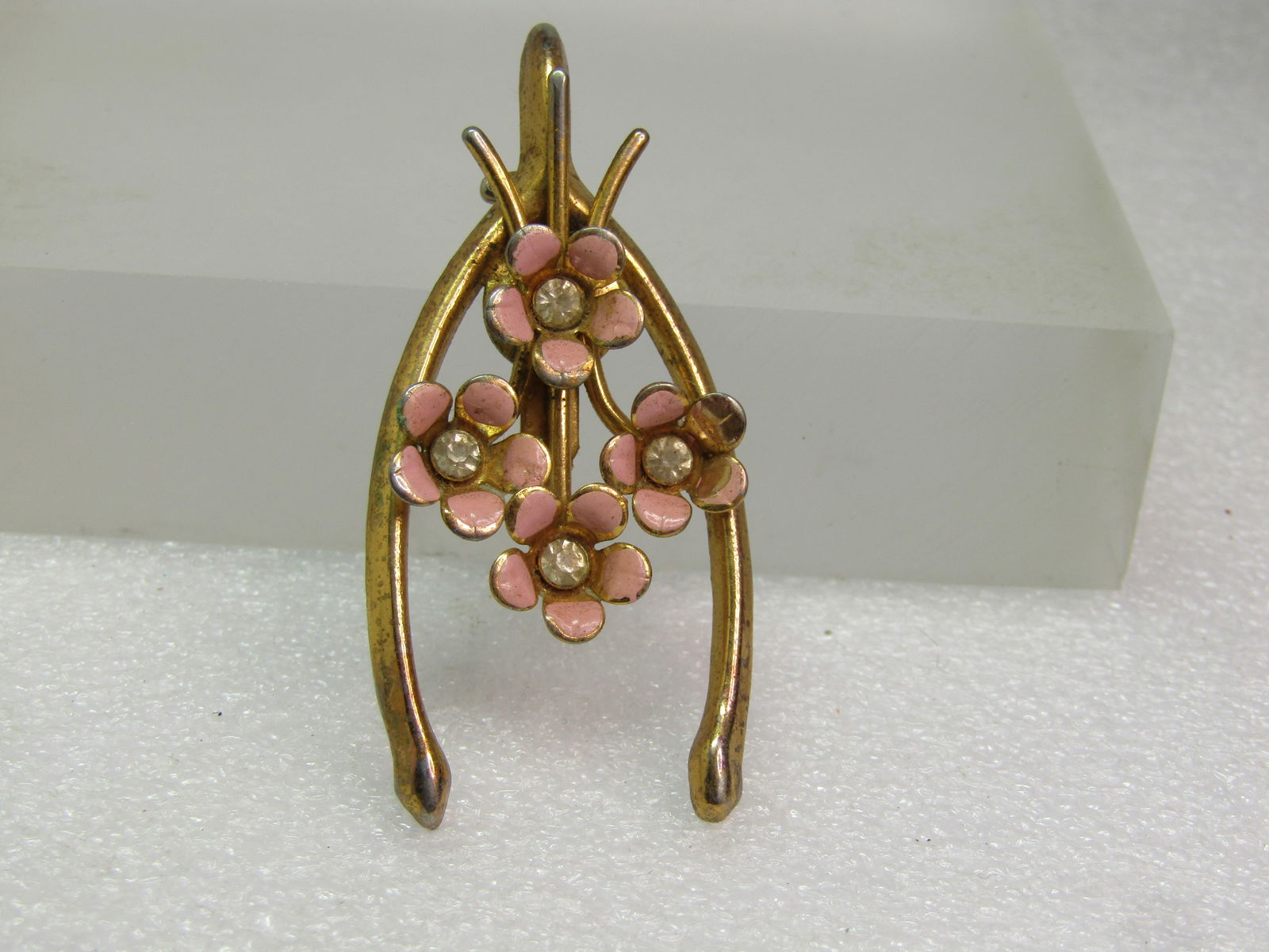 Vintage Pink Enameled Floral Wishbone Brooch, 1950's-1960's: Vintage Pink Enameled Floral Wishbone Brooch, 1950's-1960's. Good luck brooch, gold tone with four forget-me-not type blossoms in the center of the wishbone - each with a clear rhinestone center that