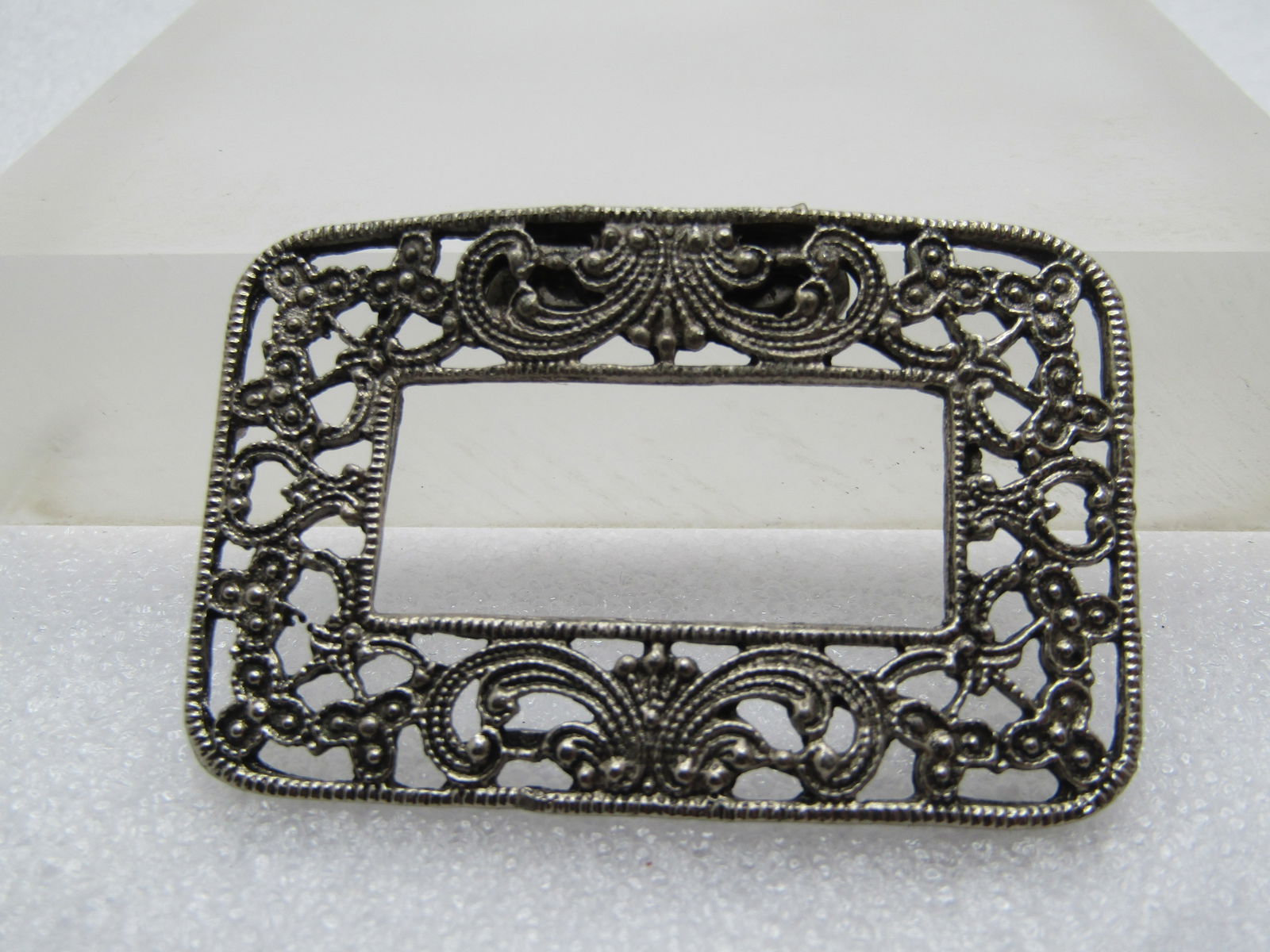Vintage Shoe/Dress Buckle, Filigree, 1930's-1940's: Vintage Shoe/Dress Buckle, Filigree, 1930's-1940's. Silver tone and rectangular with a floral and scrolled design with open work between the design and an open center. It is appx. 2-1/3" by 1.5". 