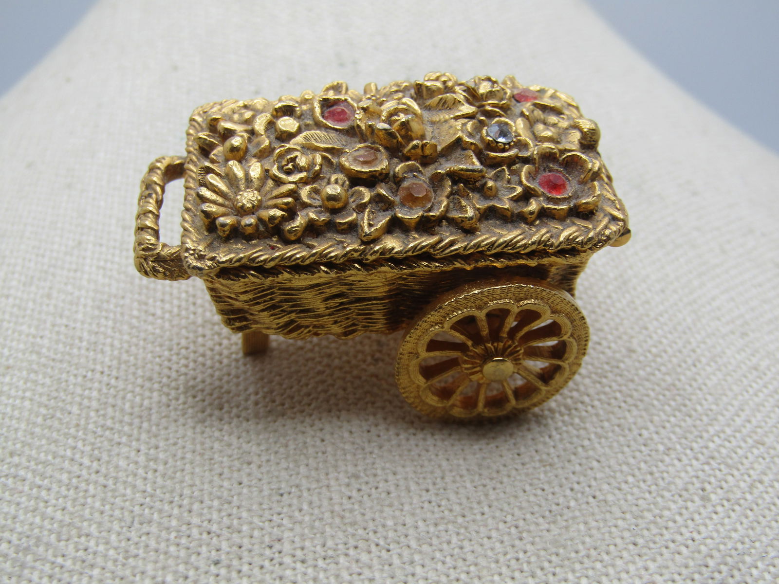 Vintage Perfume Flower Cart, Max Factor, 1960's. 2": Vintage Perfume Flower Cart, Max Factor, 1960's. Has perfume - unsure of scent but these originally held Hypnotique, 2" by 1.25" with spinning wheels. Orange and yellow rhinestones set in some of the