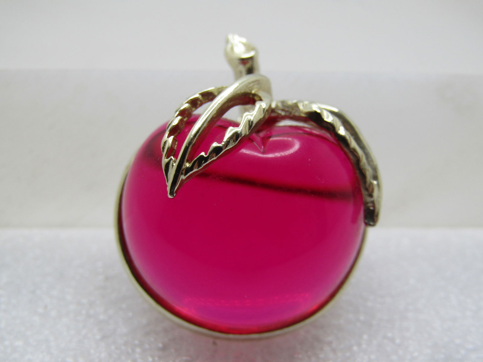 Vintage Red Lucite Cherry Brooch, Sarah Coventry, 1960's-1970's: Vintage Red Lucite Cherry Brooch, Sarah Coventry, 1960's-1970's. Gold tone stem and leaves with frame. it is appx. 1.5" by 1-1/8". It is highed rounded. In bright light it looks more dark and