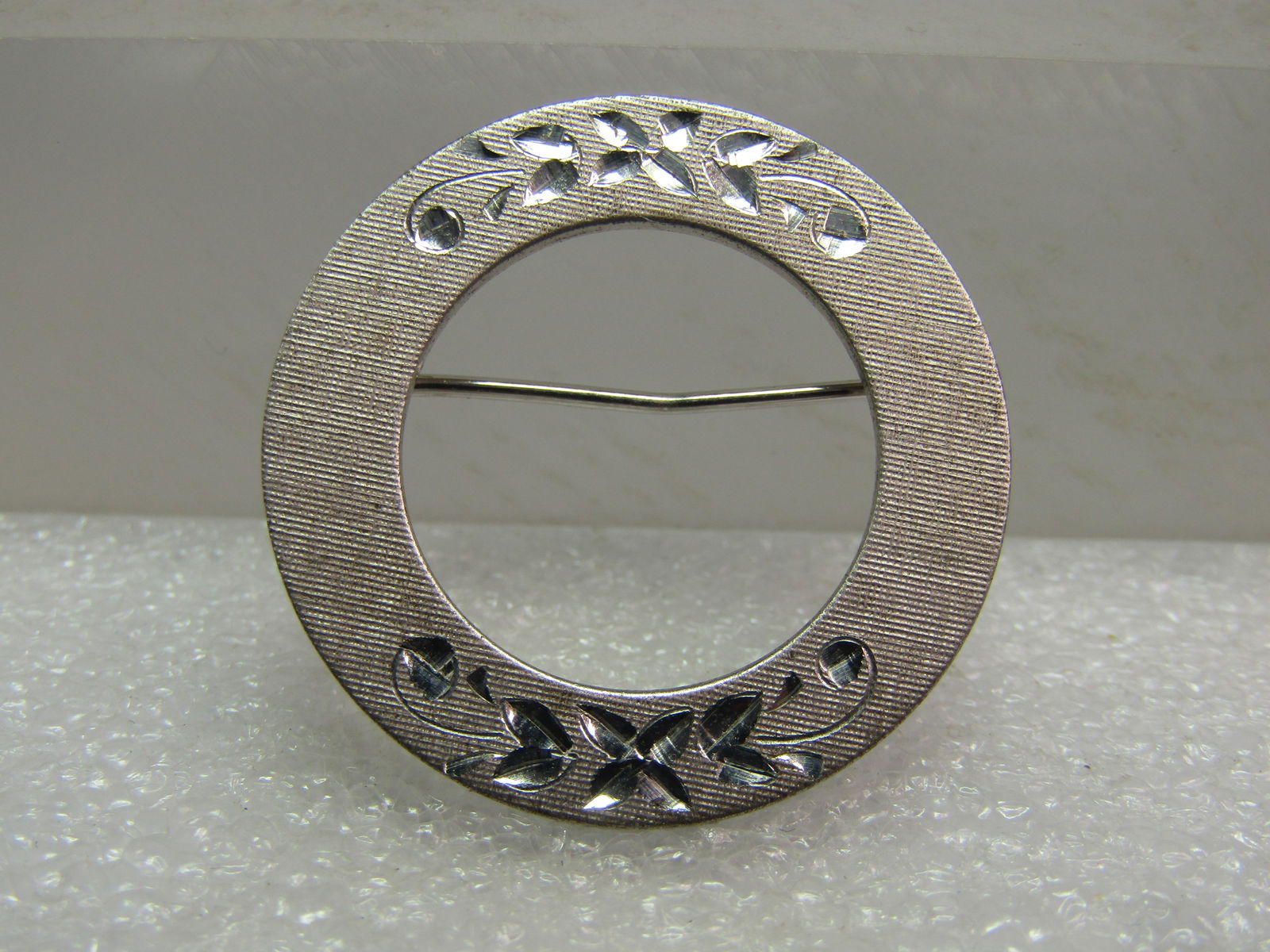 Vintage Sterling Floral Etched Brooch, Circle, Signed Wells, 1960's-1970's: Vintage Sterling Floral Etched Brooch, Circle, Signed Wells, 1960's-1970's. It is marked sterling, tests as sterling with an appx. weight of 4.29 grams. Signed Wells. The brooch ahs a brushed