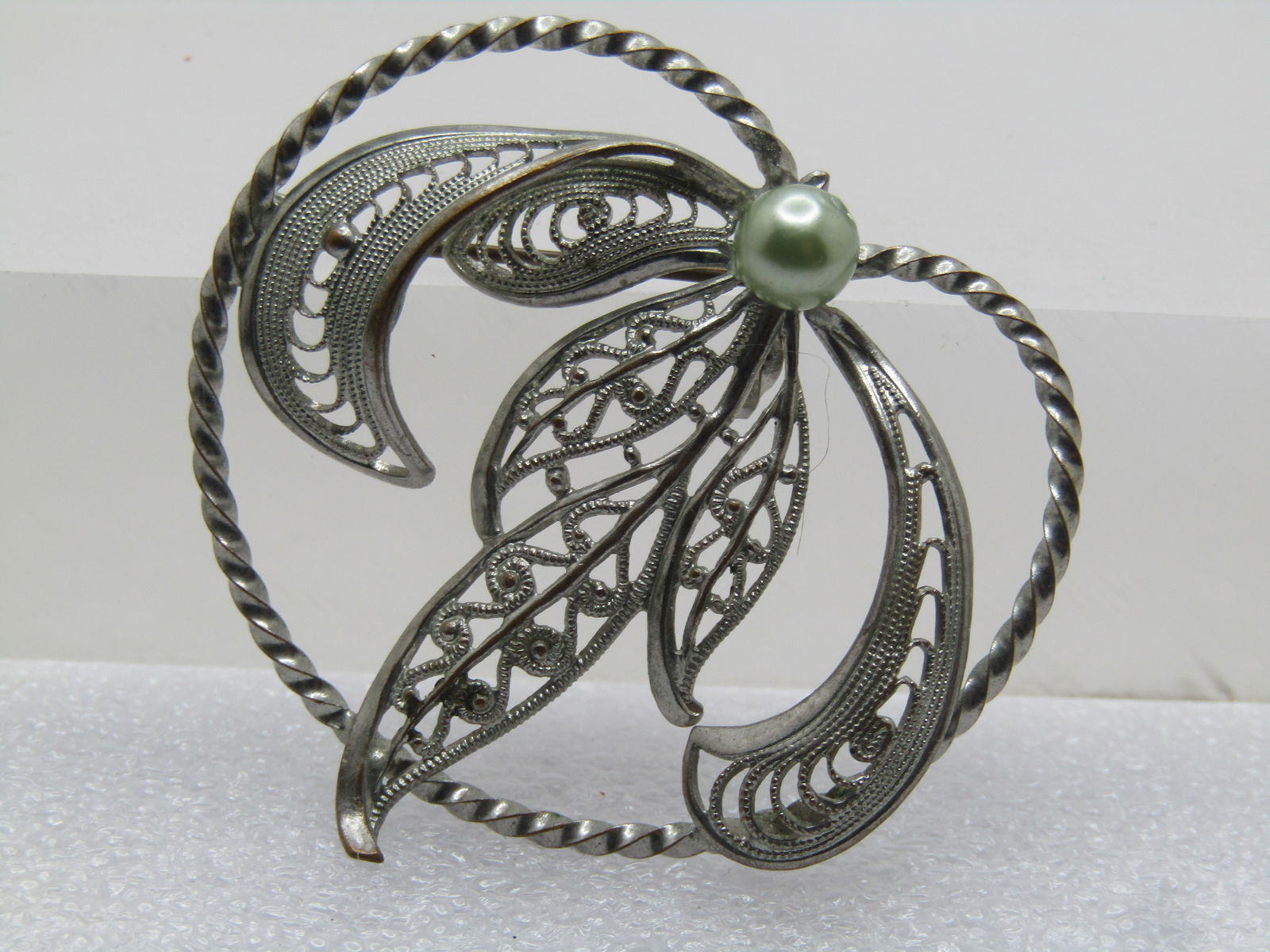 Vintage Filigree Leaf & Faux Pearl Brooch, 1940's: Vintage Filigree Leaf & Faux Pearl Brooch, 1940's, C-Clasp and signed Western Germany. It is Heart shaped subtely with a main filigree triple blade leaf in the center, twisted rope frame and filigree