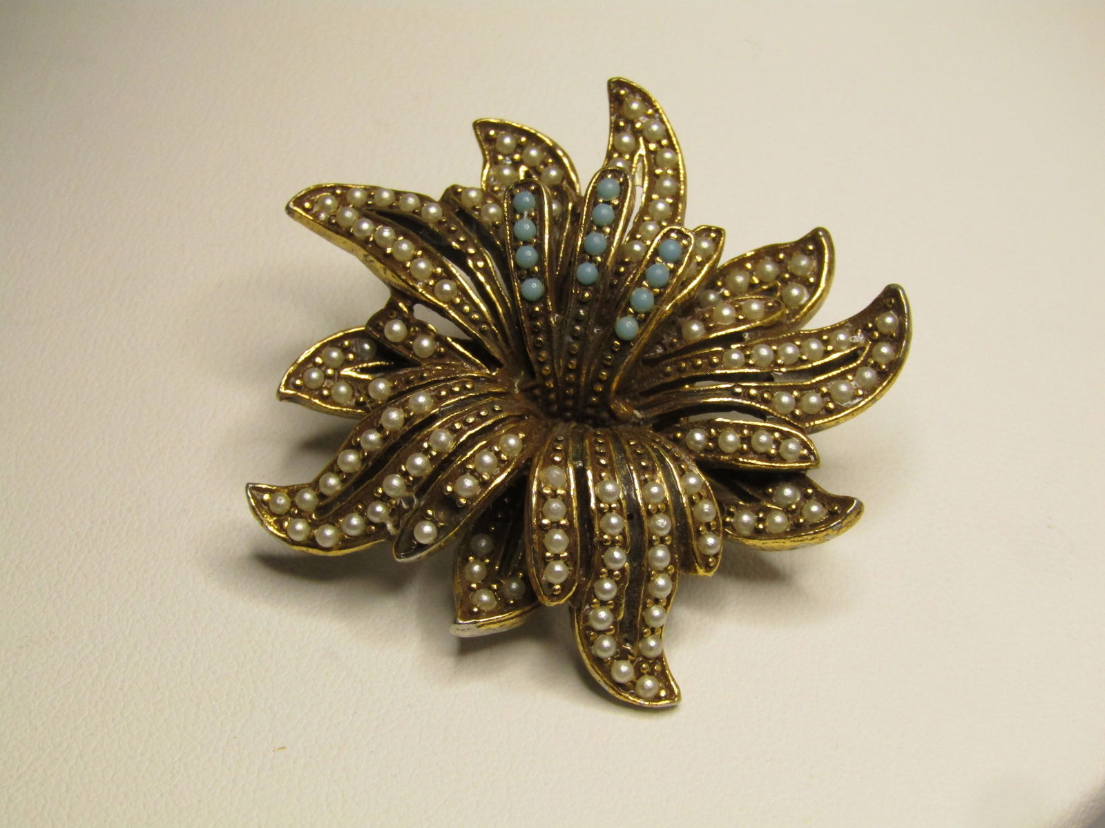 Vintage Floral Faux Pearl Turquoise Brooch, Florenza, 1950's: Vintage Floral Faux Pearl Turquoise Brooch, Florenza, 1950's. Gold tone. This has layers to this brooch with pointed petals with open centers lined with small faux pearls and a central triple
