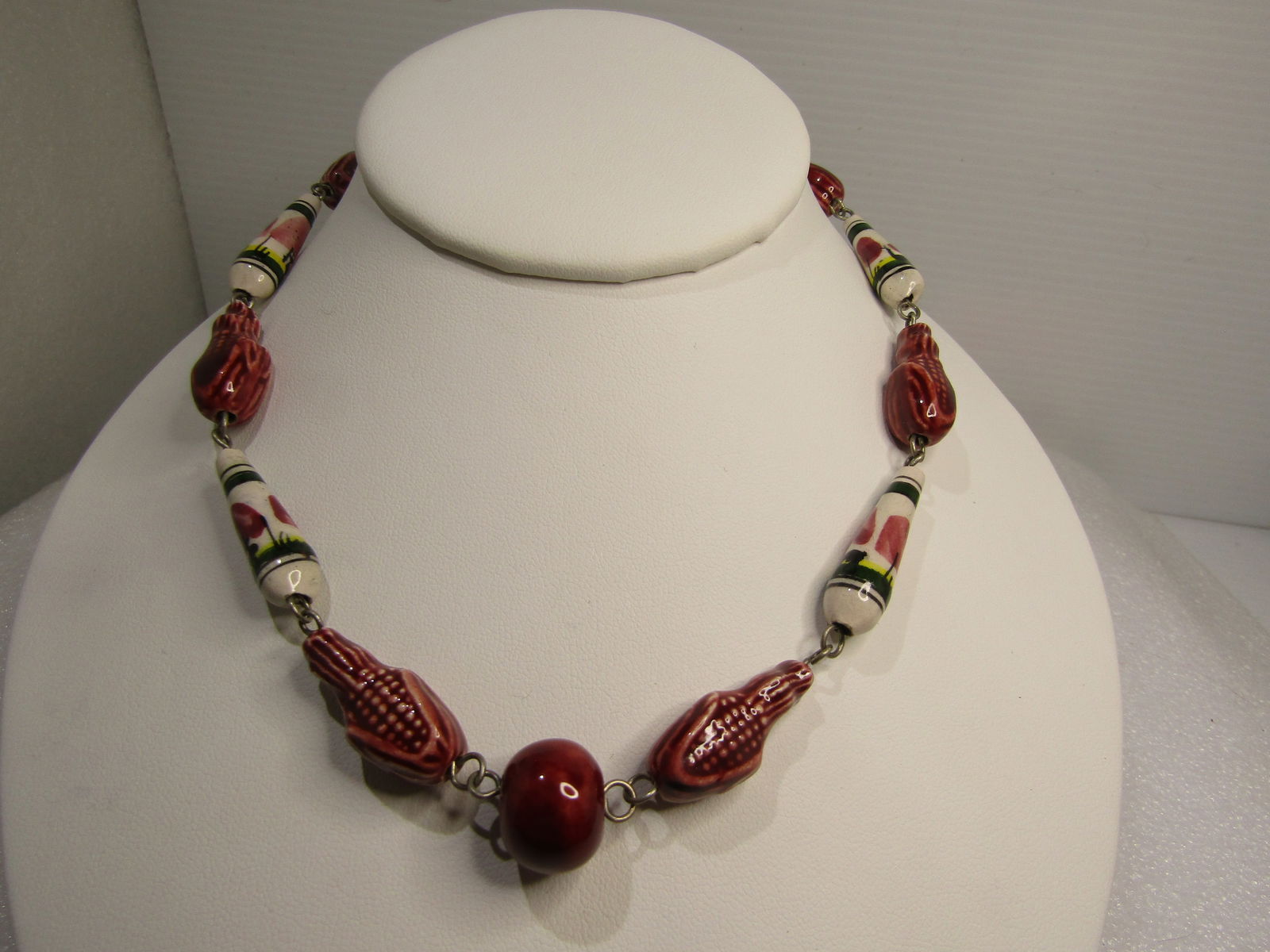 Vintage Ceramic Scenic & Corn Beaded Necklace, 22", Hook Clasp, 1970's: Vintage Ceramic Scenic & Corn Beaded Necklace, 22", Hook Clasp. The beads alternate with a deep maroon tone bead that looks like an ear of corn opened to expose the kernels alternating with white