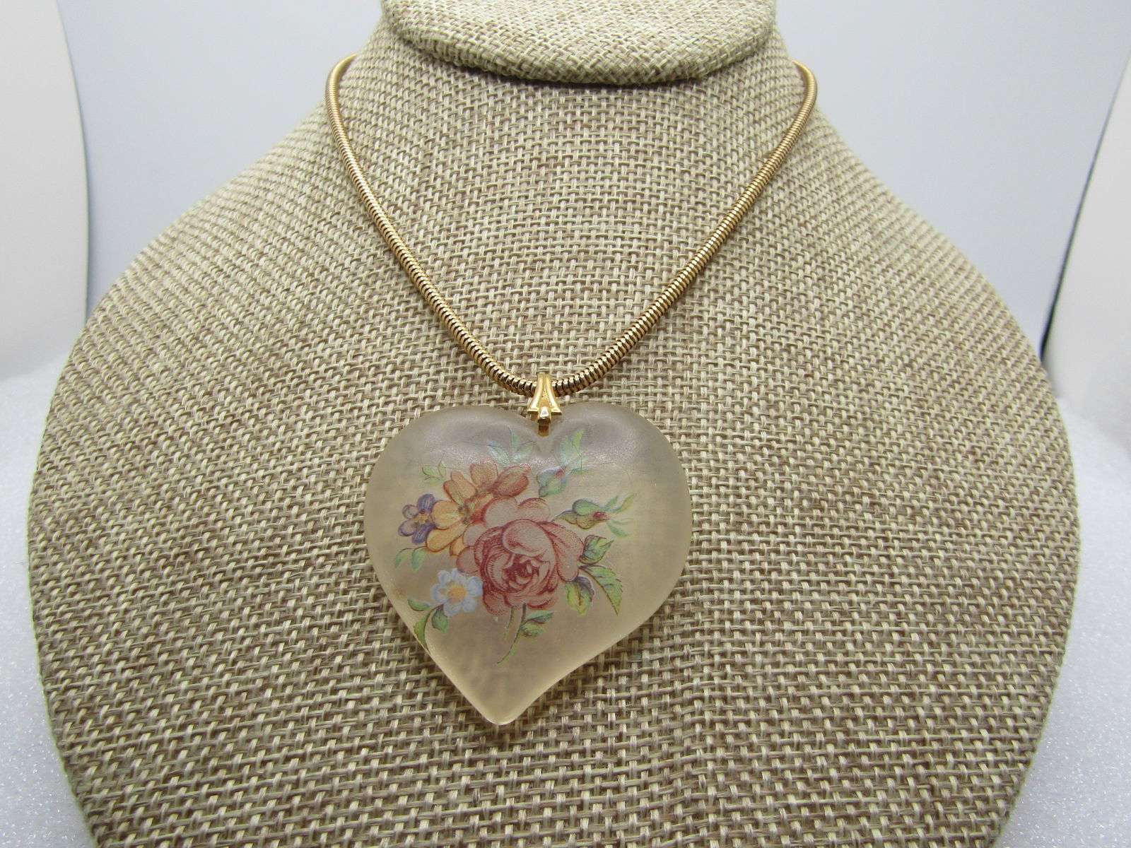 Vintage Frosted Floral Heart Necklace, 22", 1960's-1970's: Vintage Frosted Floral Heart Necklace, 22", 1960's-1970's. Gold tone appx. 2.5mm round snake chain with spring ring clasp. The heart is a frosty clear 1.75" talla dn wide puffy heart pendant that