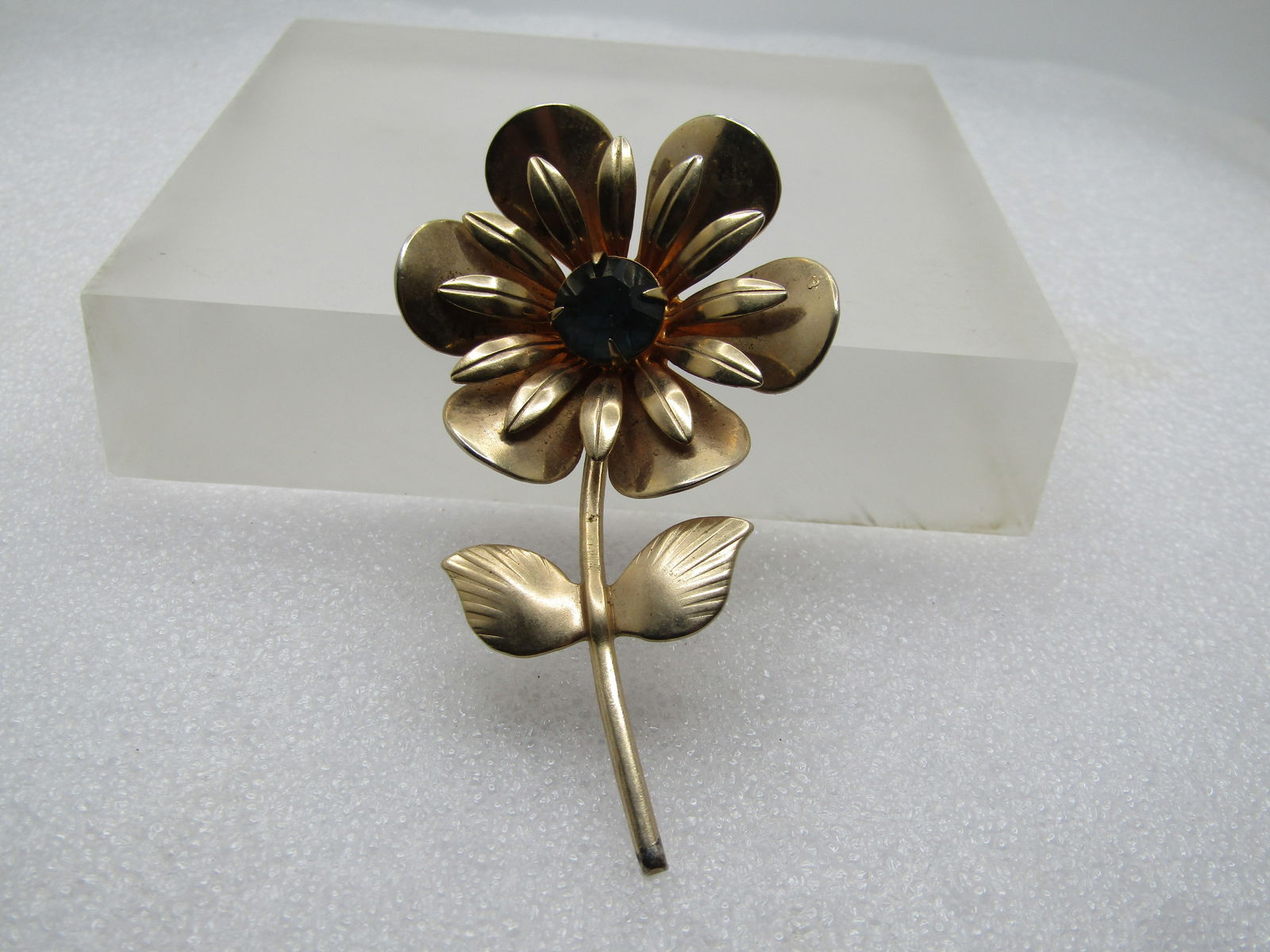 Vintage Blue Rhinestone Floral Stem Brooch, 1940's-1950's: Vintage Blue Rhinestone Floral Stem Brooch, 1940's-1950's. This has a two-tiered blossom with rounded petals on the bottom that point slightly upward with longer more pointed petals in the center. And