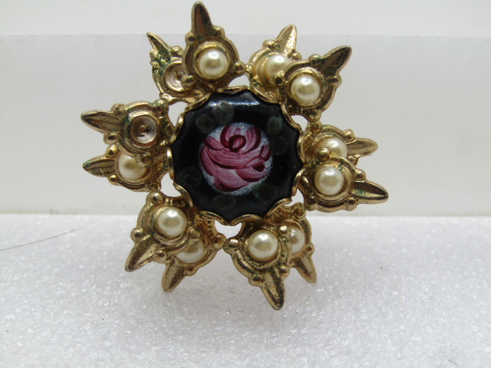 Vintage Enameled Rose Brooch, Faux Pearl's, 1950's-1960's: Vintage Enameled Rose Brooch, Faux Pearl's, 1950's-1960's. Gold tone and poinated with two tiers of pointed rays, each with a faux pearl that is appx. 2.5mm wide. The center is a blackglass 11mm round
