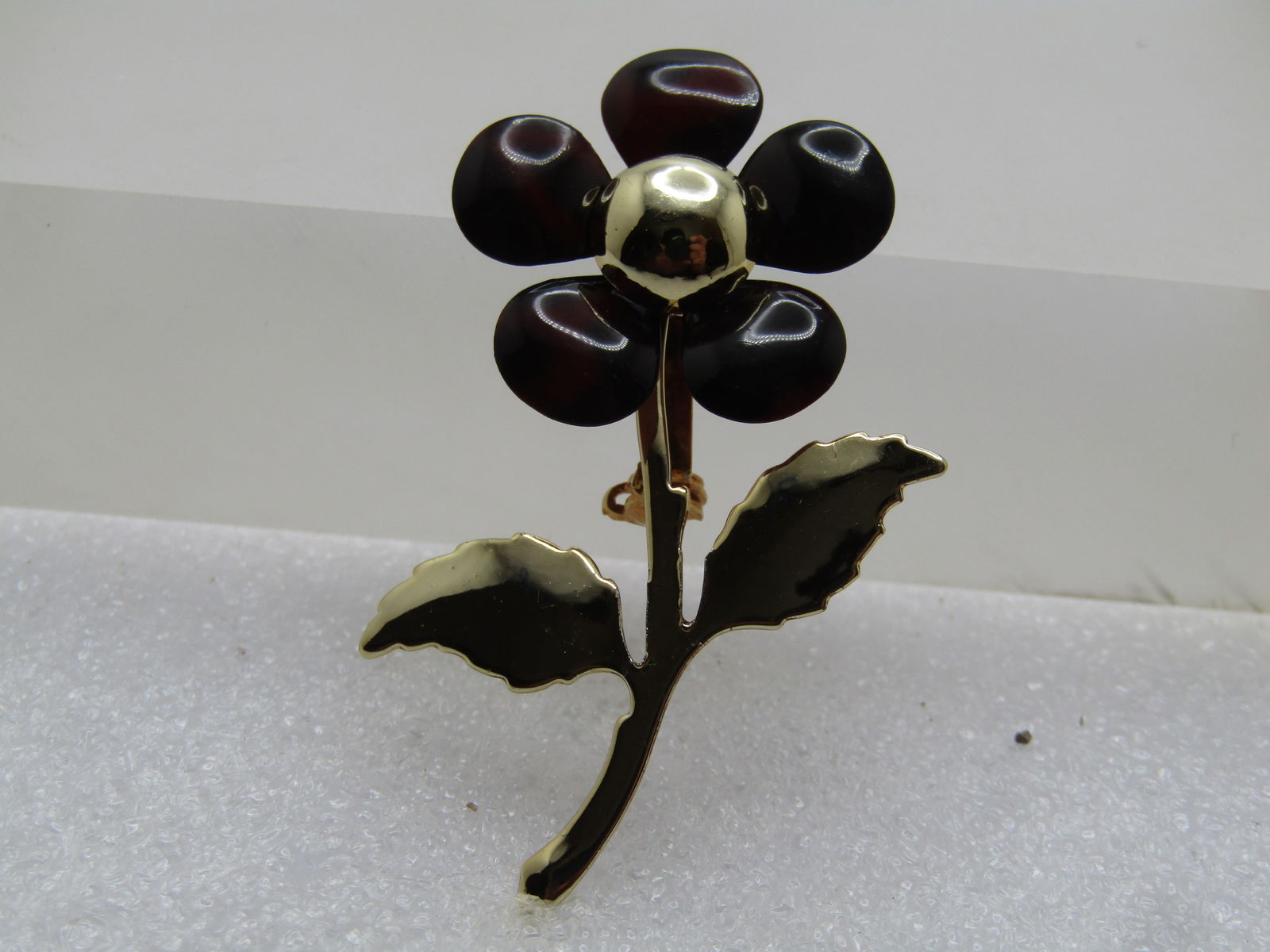 Vintage Black/Brown Enameled Floral Brooch, 1960's: Vintage Black/Brown Enameled Floral Brooch, 1960's. The brooch's petals are enameled and the remainder of the brooch is gold tone wit a domed center to the blossom. The brooch is appx. 2" tall and 1.2