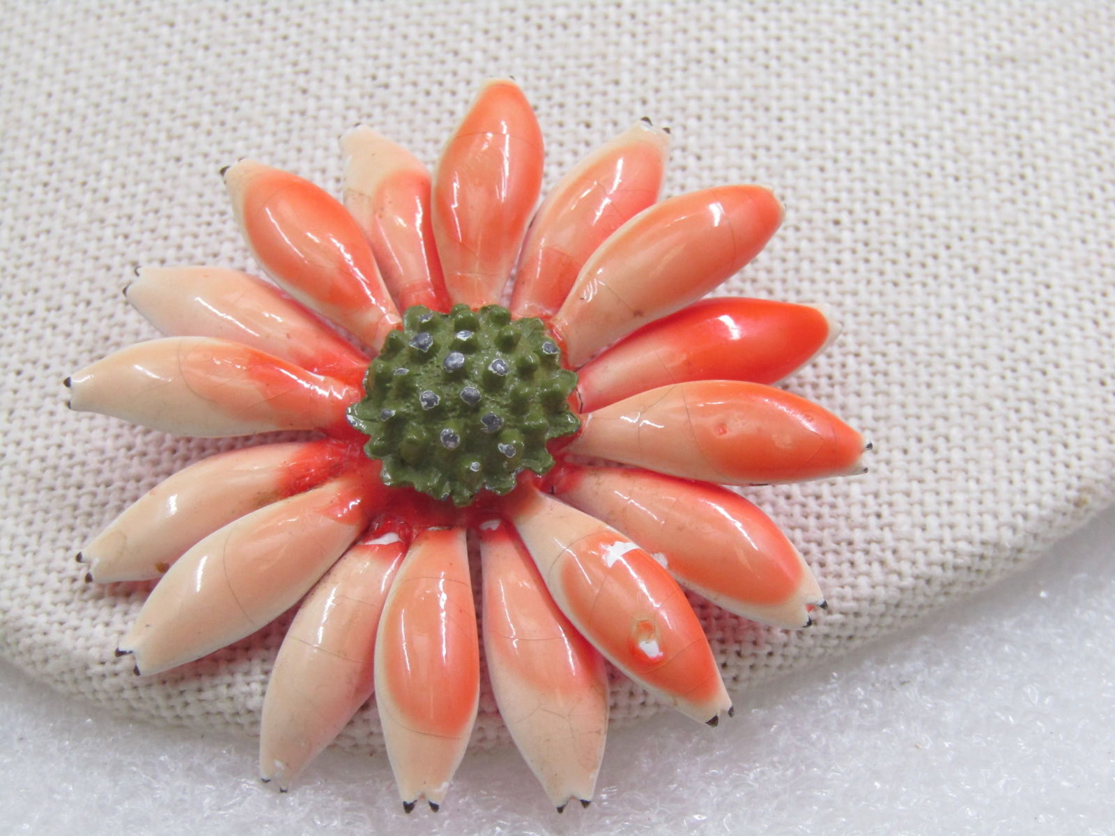Vintage Orange/Cream Enameled Brooch, Floral, 1.5" wide. 1960's: Vintage Orange/Cream Enameled Brooch, Floral, 1.5" wide. 1960's . Shades of orange on the dome, domed petals enameled with a center green dotted dome accent. Daisy-like flower. Pink enameling on the