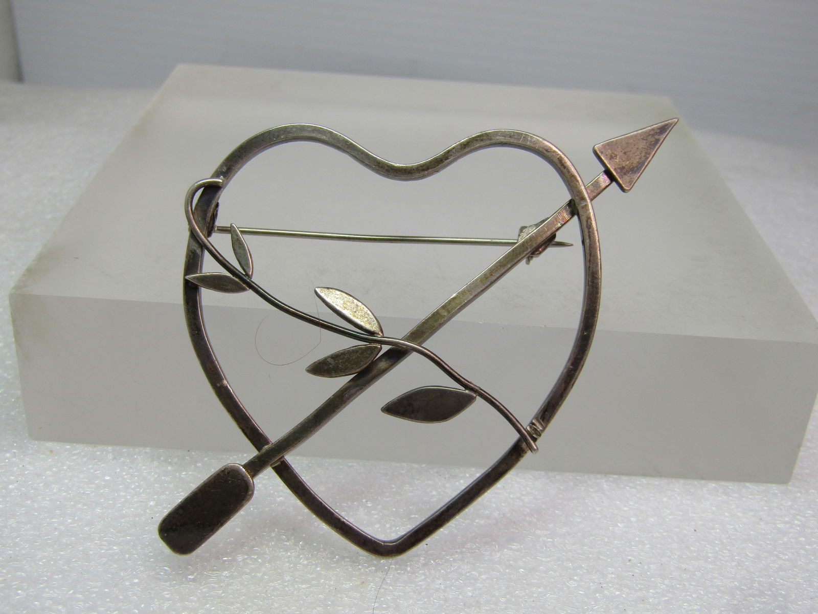 Vintage Sterling Heart/Arrow/Leaf Brooch, 1960's-1970's: Vintage Sterling Heart/Arrow/Leaf Brooch, 1960's-1970's. This is a large brooch with a modernist look to it in the way it is made - long locking clasp. It is appx, 2.5" tall and wide from arrow