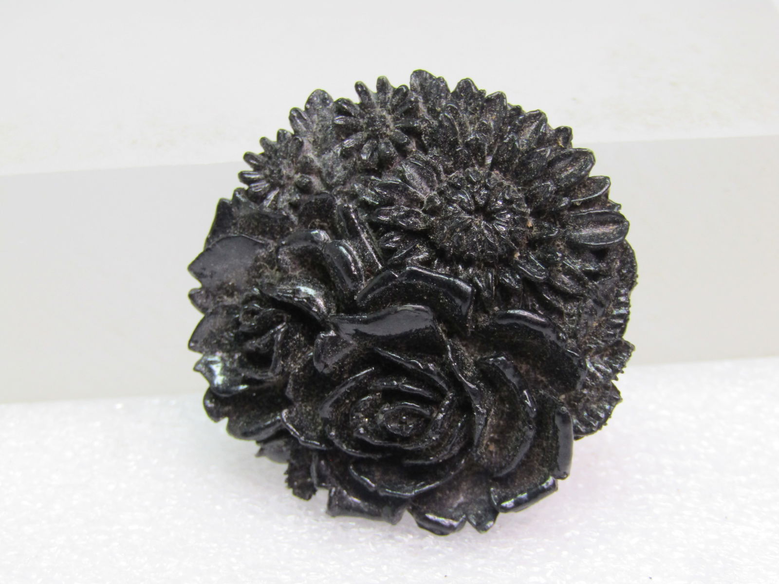 Vintage Black Floral Celuloid Brooch, 1940's-1950's: Vintage Black Floral Celuloid Brooch, 1940's-1950's. Mourning brooch. This appears to be half daisies and mum-type flowers . The brooch is a black celluloid and is just under 1.5" across and domed