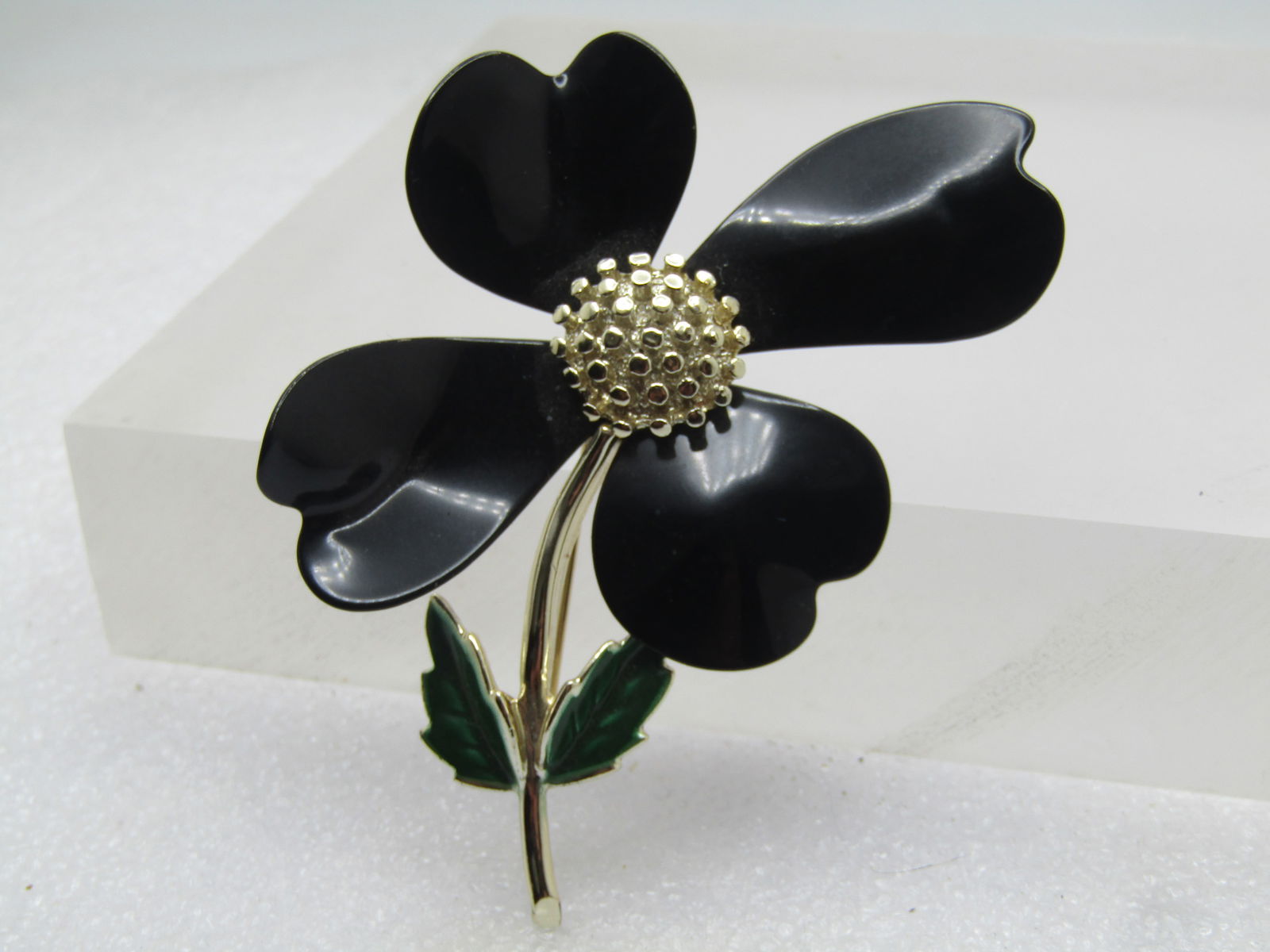 Vintage Black Enameled Floral Stem Brooch, Sarah Coventry, 1960's-1970's: Vintage Black Enameled Floral Stem Brooch, Sarah Coventry, 1960's-1970's. This has four petals that are slightly different and a bid abstrack - heart-shaped pet als with some being longer or
