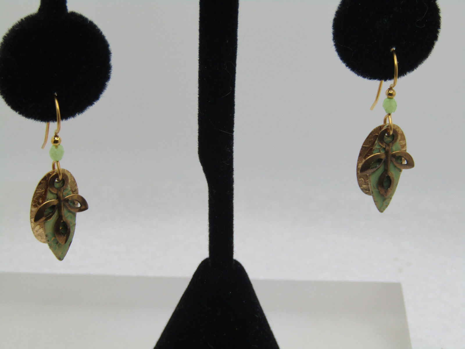 Vintage Leaf & Floral Dangle Earrings, Enameled, 1980's-1990's: Vintage Leaf & Floral Dangle Earrings, Enameled, 1980's-1990's. Gold tone with three dangles that overlap - a slightly domed oval gold tone with raised floral designs and textured backgroud with a