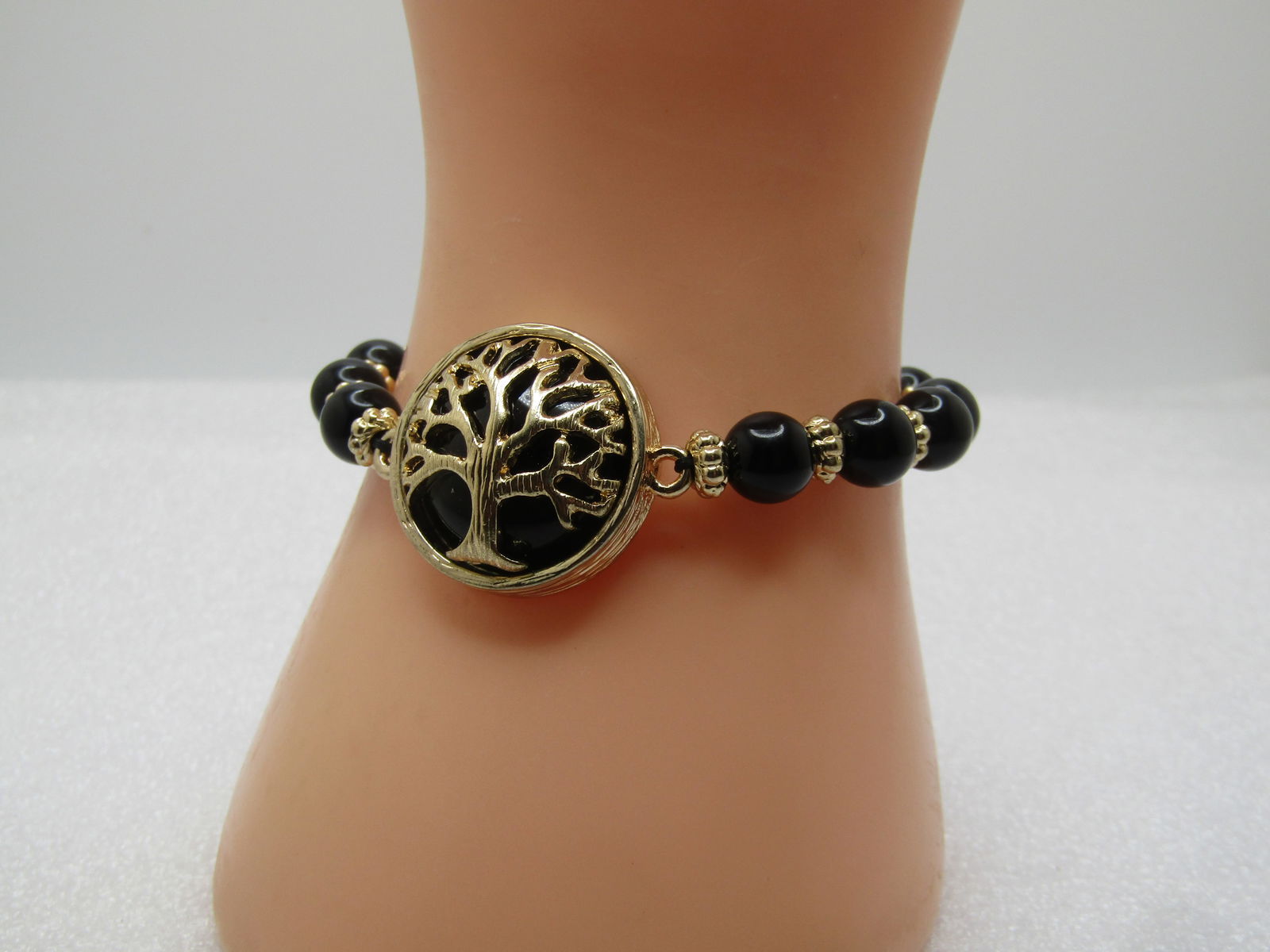 Vintage Black Beaded Tree Bracelet, Stretch, 5.5"-6", 1980's-1990's: Vintage Black Beaded Tree Bracelet, Stretch, 5.5"-6", 1980's-1990's. Gold tone with a large domed black lucite bead set with a dome tree outline over top. This is appx. 1" round. The bracelet is