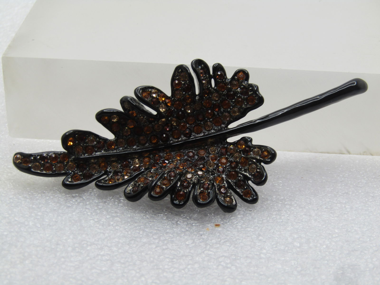 Vintage Black Enameled Rhinestone Leaf Brooch, Kenneth Lane, 1990's: Vintage Black Enameled Rhinestone Leaf Brooch, Kenneth Lane, 1990's. Black Enameled leaf with shades of honey and amber rhinestones set throughout the leaf. It has a curved design with the center
