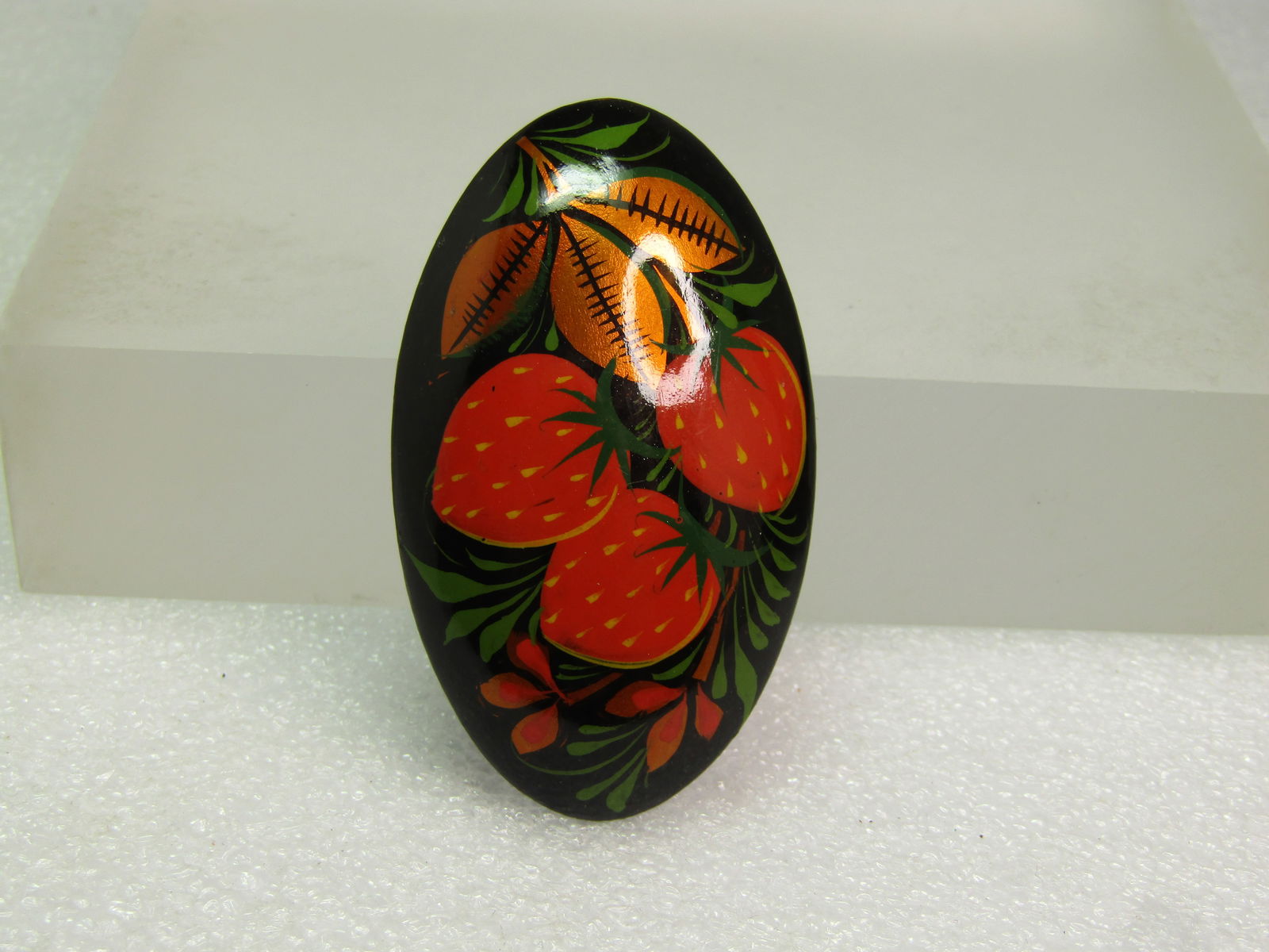 Vintage Black Lacquered Strawberry Brooch, Wood, 1960's-1970's: Vintage Black Lacquered Strawberry Brooch, Wood, 1960's-1970's. Handmade. Domed wooden base with black bacground painted with strawberrys in red and green and coppery leaves with shading detail of